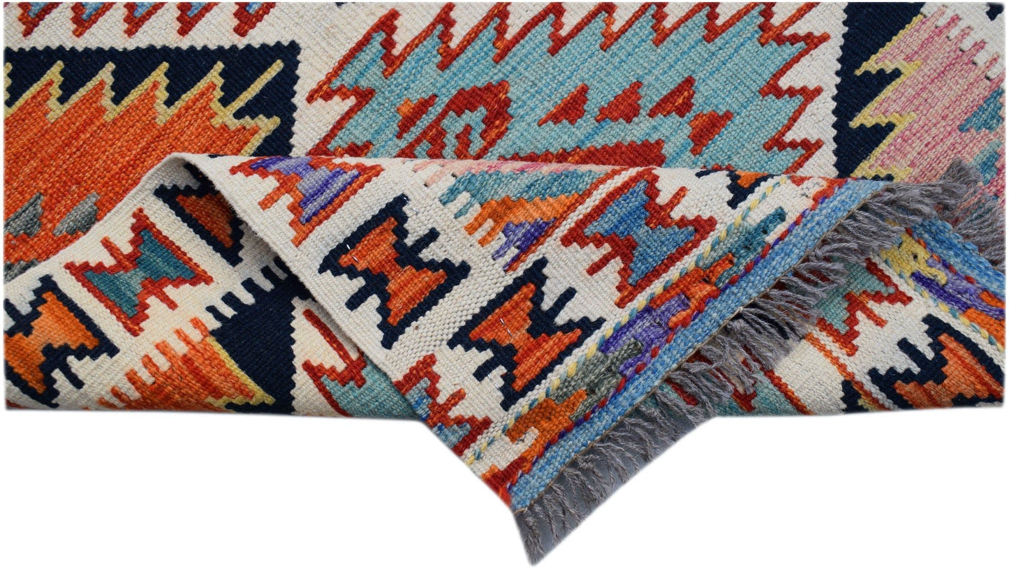 A handwoven Afghan Maimana Kilim runner featuring vibrant geometric patterns in wool.