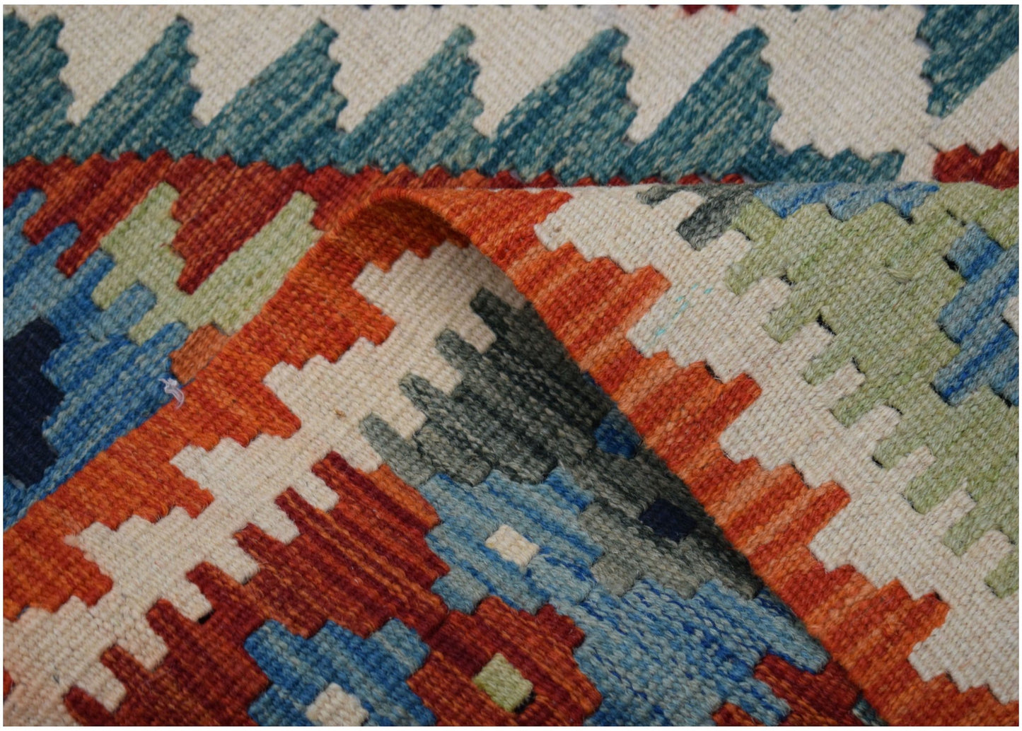 A handmade Afghan Maimana kilim runner featuring a geometric pattern in vibrant wool colors.
