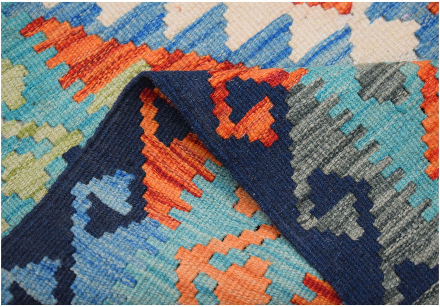 A handwoven Afghan Maimana kilim runner featuring a vibrant geometric pattern in wool.