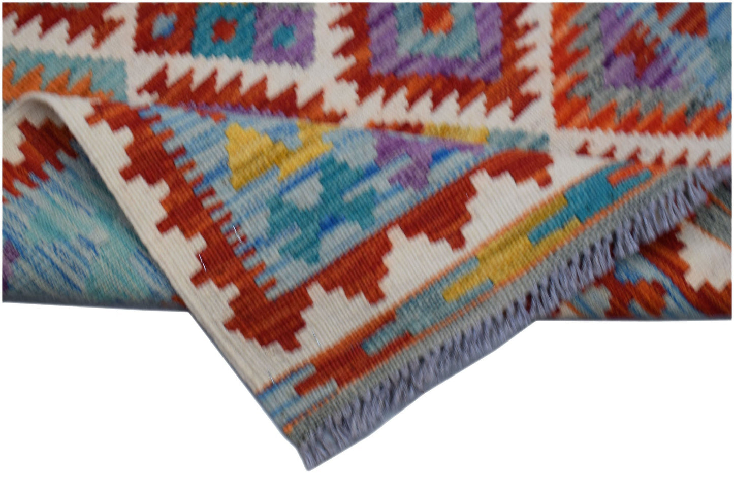 A handmade Afghan Maimana kilim runner featuring a vibrant geometric pattern in wool.