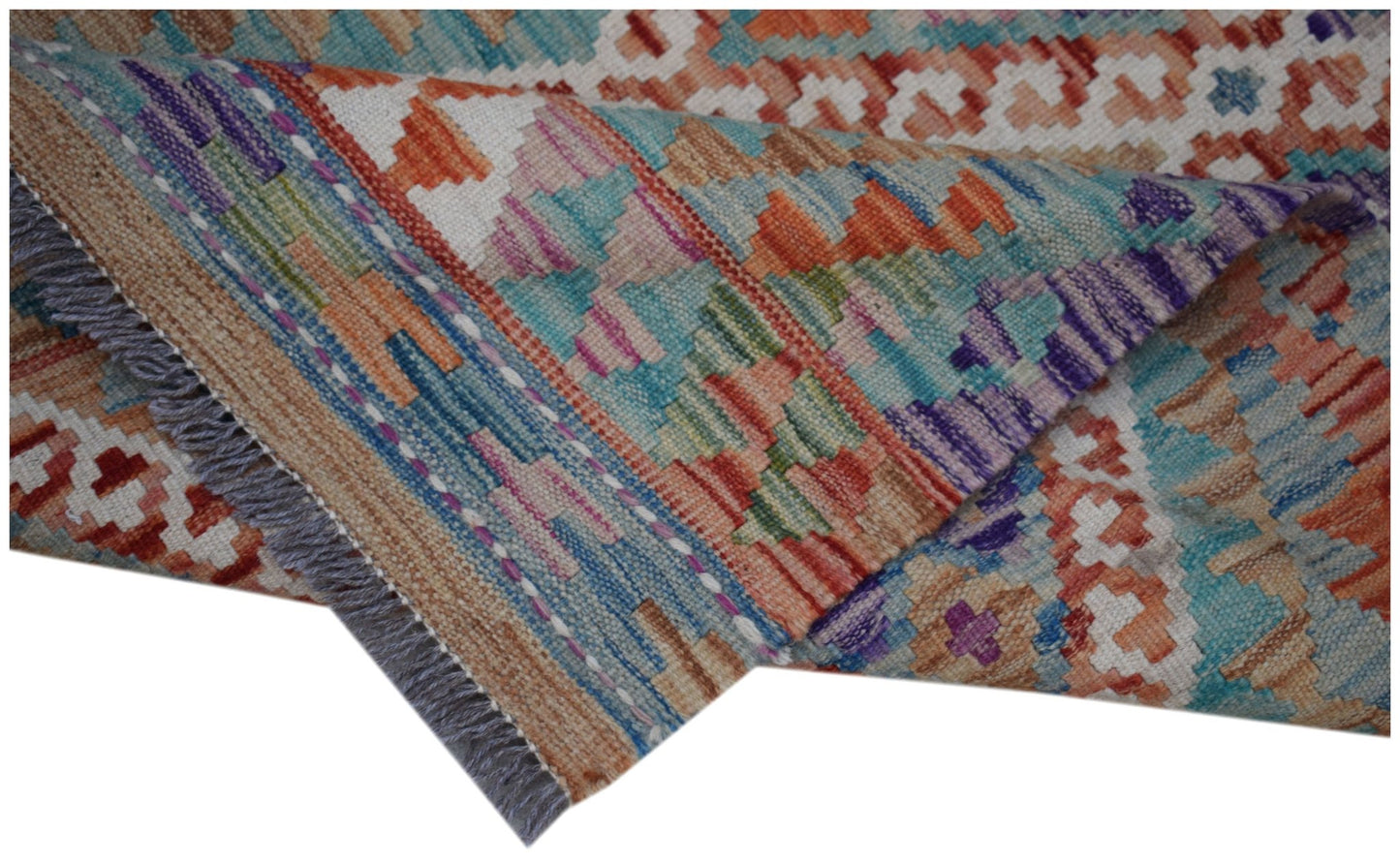 A handmade Afghan Maimana kilim runner featuring a colorful geometric pattern and fringed edges.