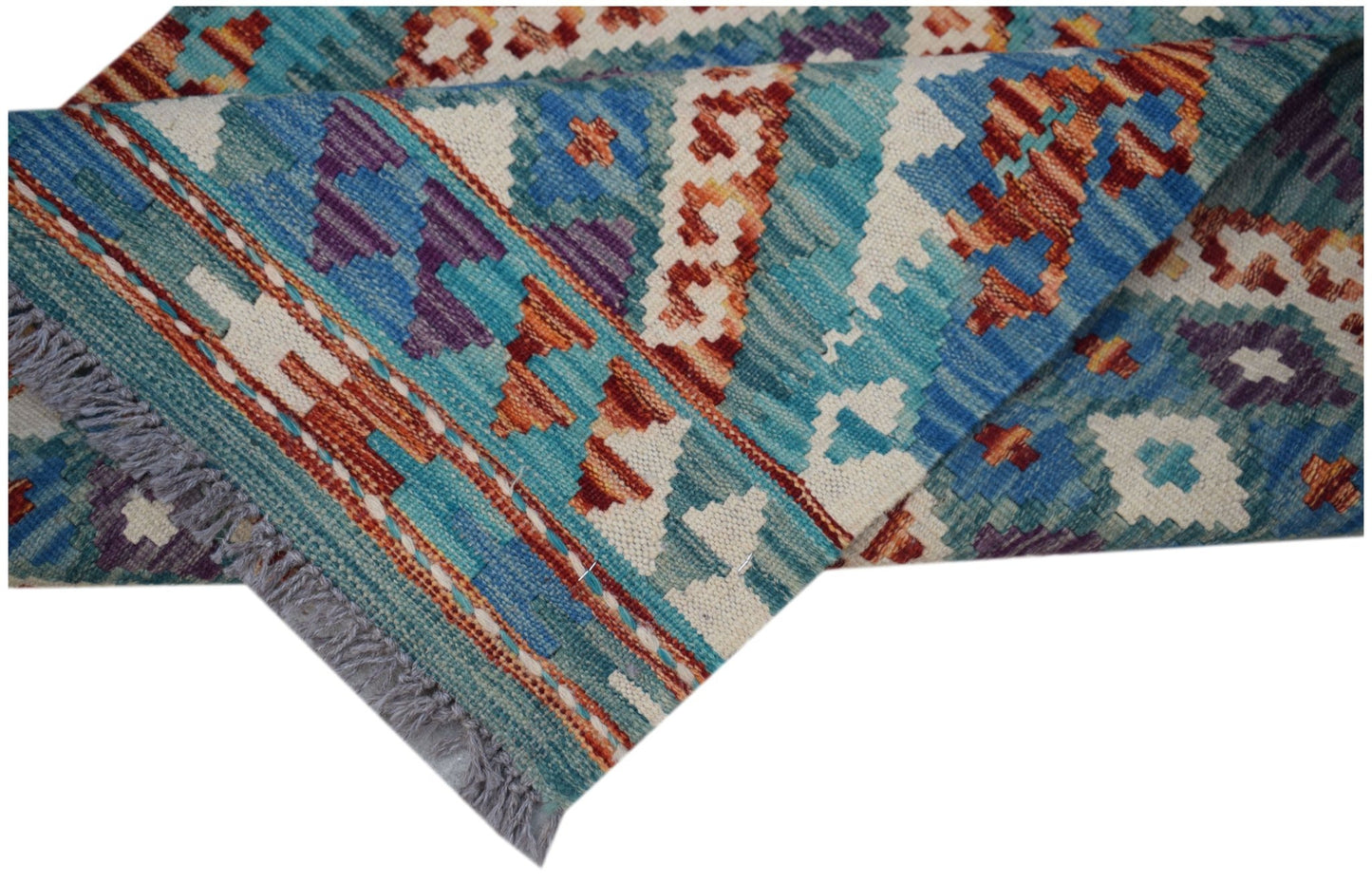 A handmade Afghan Maimana wool kilim runner featuring geometric patterns in blue and orange.