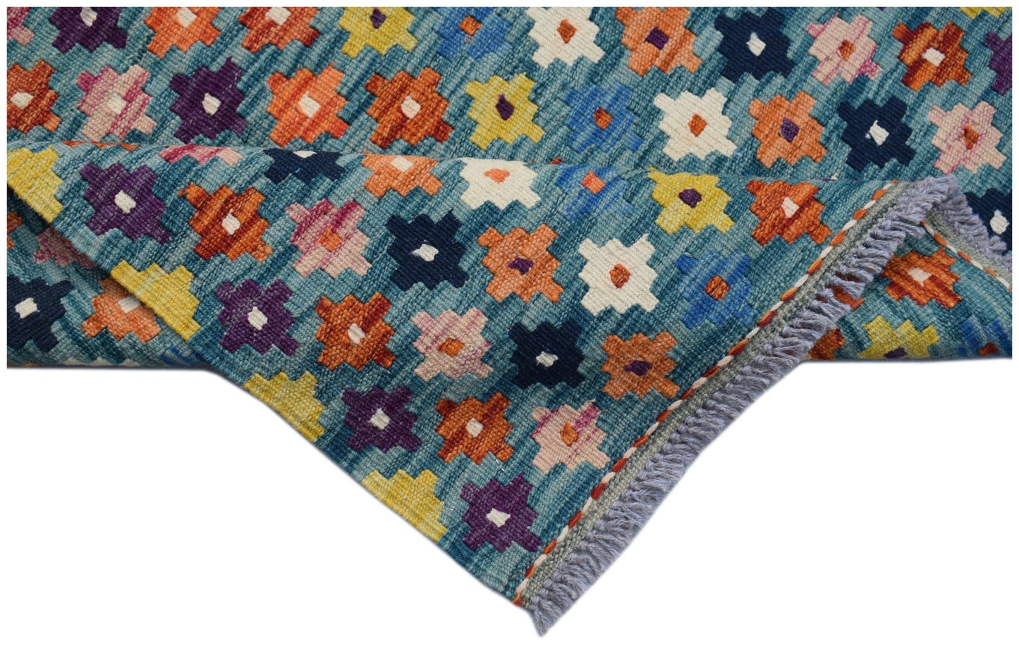 Handwoven Afghan Maimana kilim runner featuring a colorful geometric pattern on a blue background.