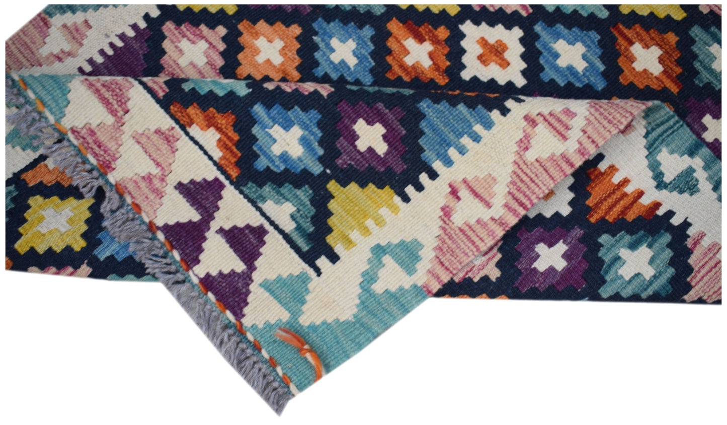 Handwoven Afghan Maimana wool kilim runner featuring a colorful geometric pattern.