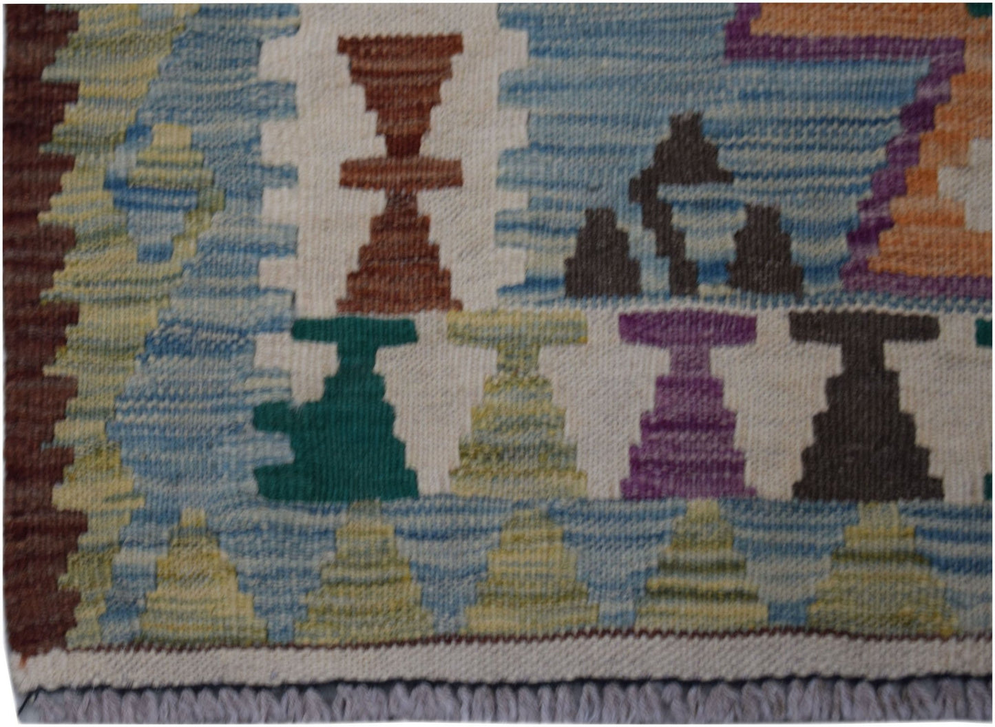 Handwoven Afghan Maimana wool runner featuring colorful geometric motifs on a cream background.