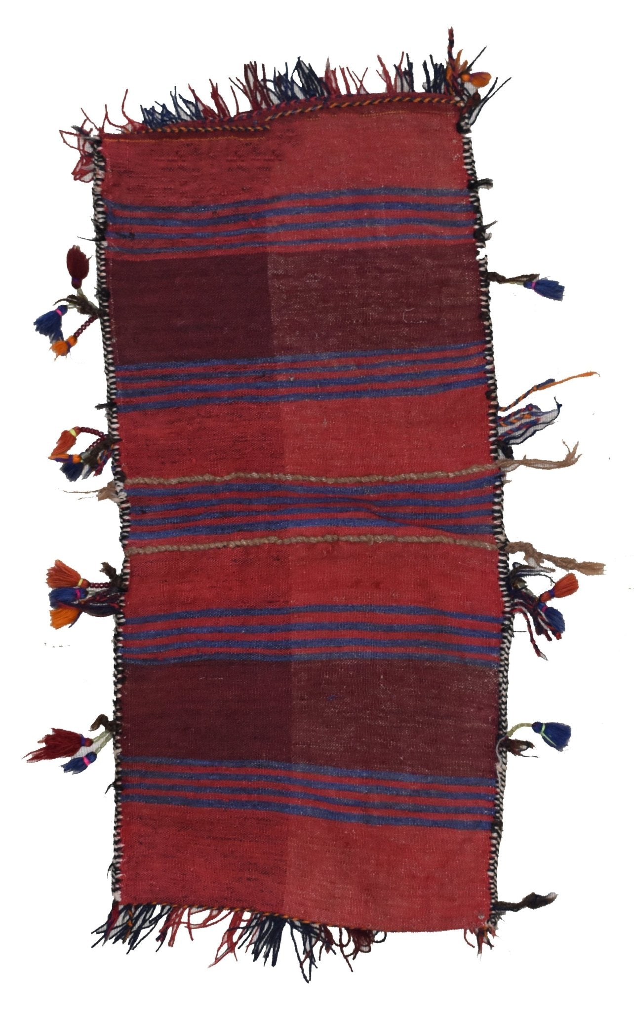 A handmade vintage Afghan wool saddle bag featuring red and blue striped patterns with tassels.