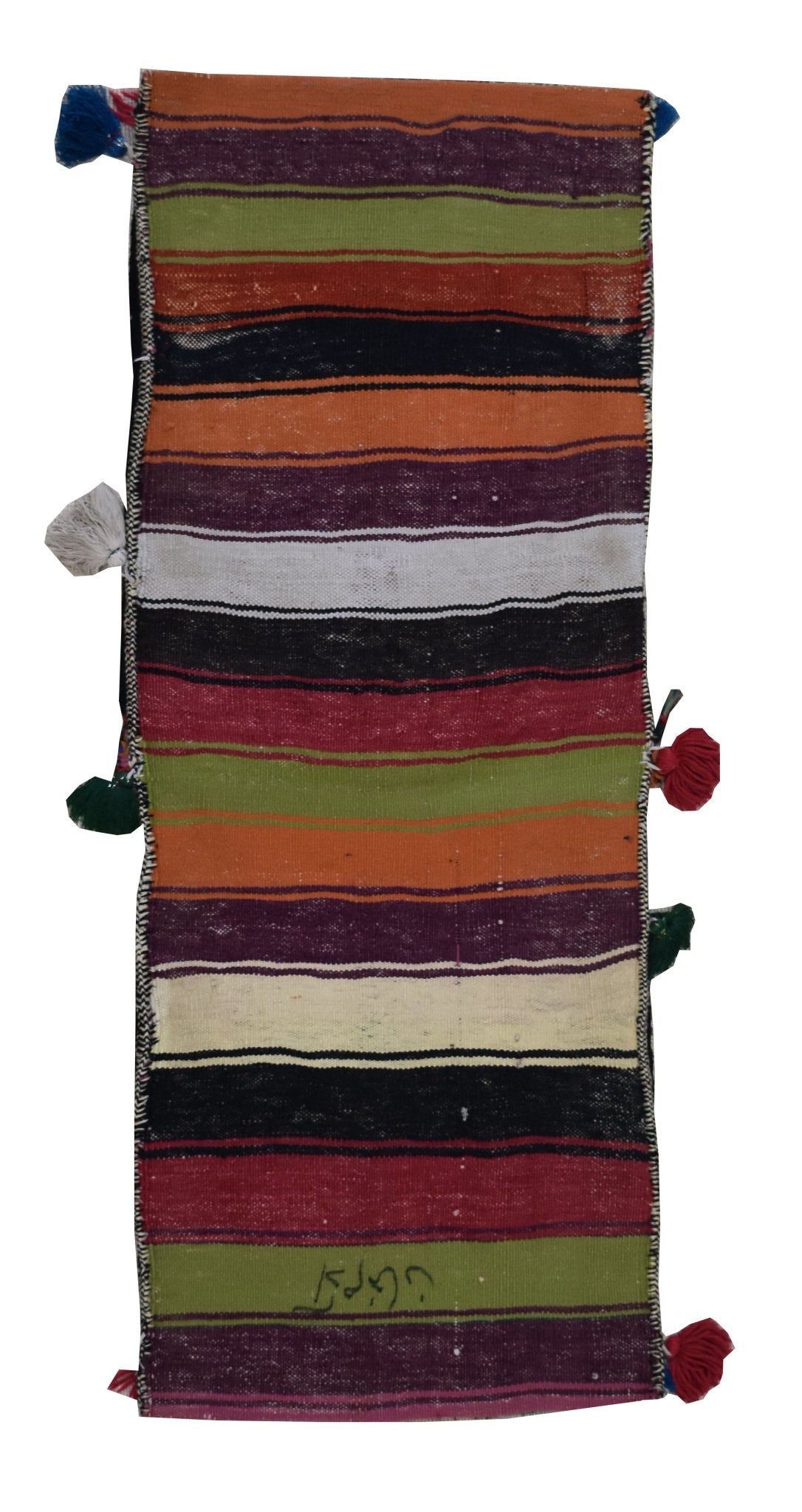 A vintage handmade Afghan wool saddle bag featuring colorful horizontal stripes and side tassels.