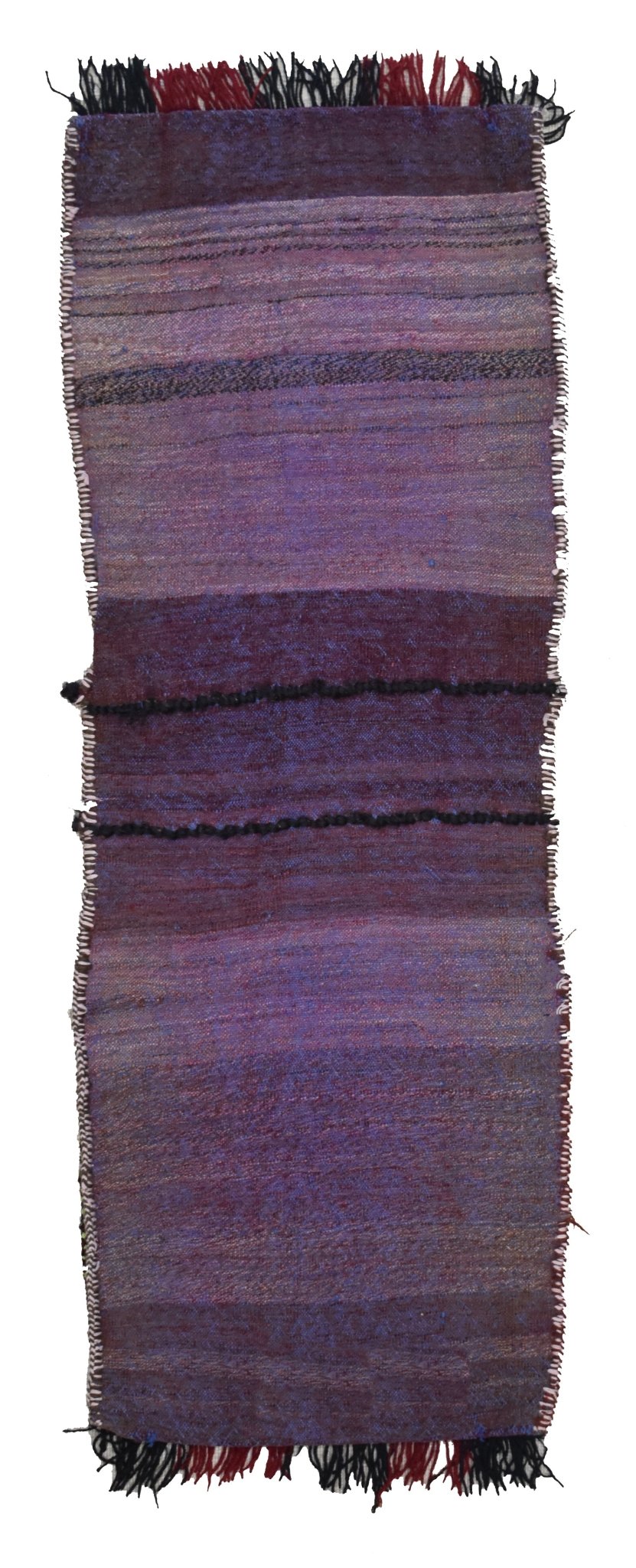 A handmade vintage Afghan wool saddle bag featuring purple and red striped patterns with fringe.