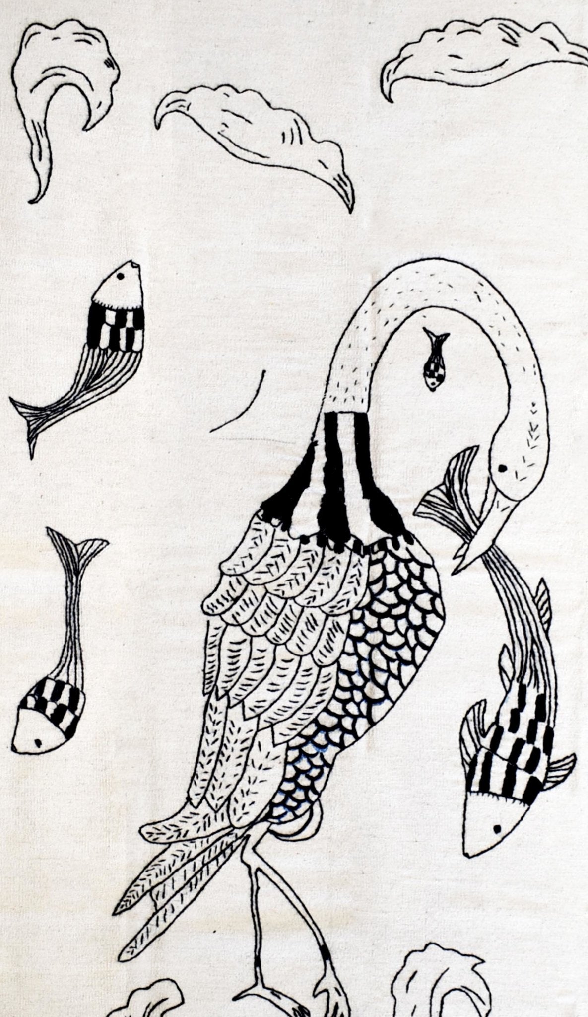 Hand-embroidered wool kilim featuring a black and white line art design of a bird and fish.