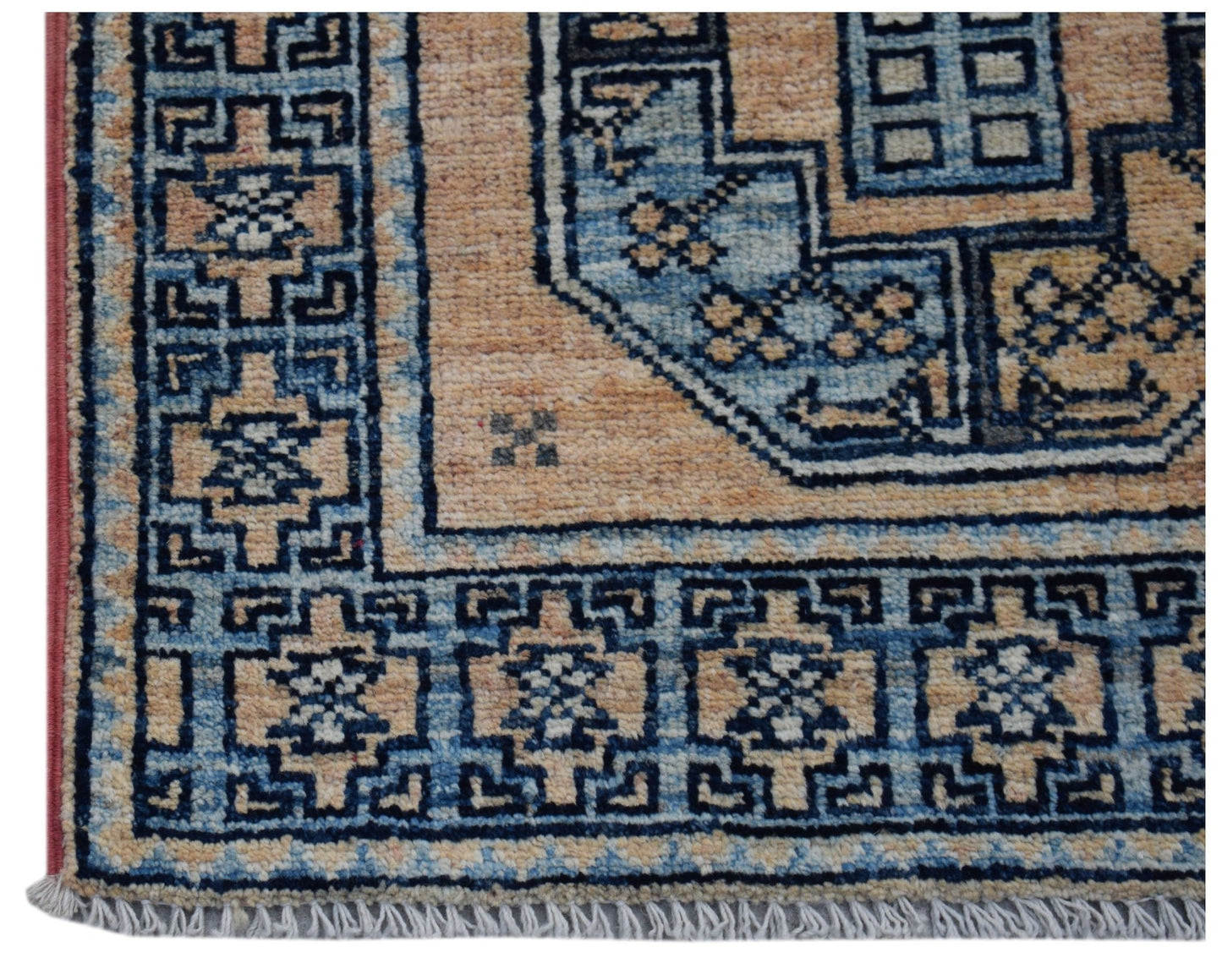 A handmade Afghan Chobi rug featuring a geometric blue and tan pattern with a fringed edge.