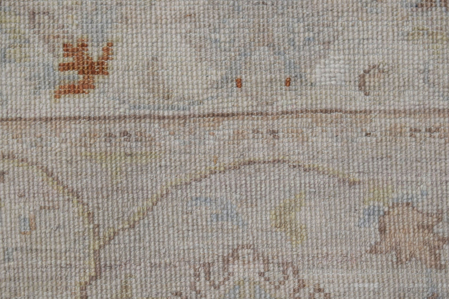 A close-up of a handwoven Afghan Chobi rug featuring a neutral palette with subtle floral motifs.