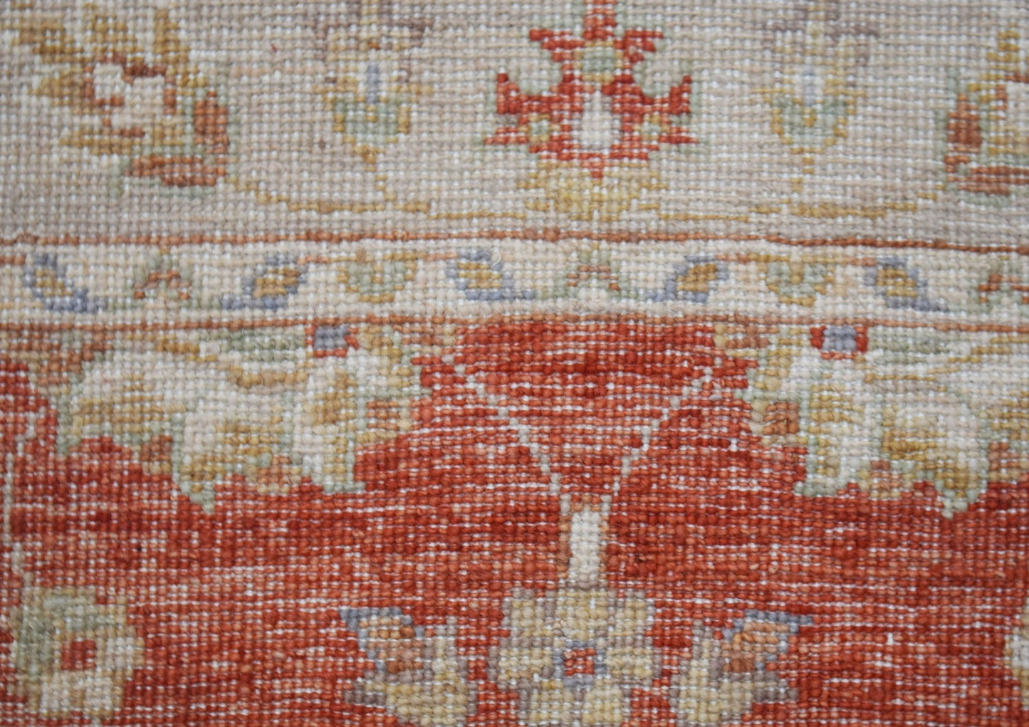A close-up of a handwoven Afghan Chobi runner featuring traditional floral patterns in earthy tones.