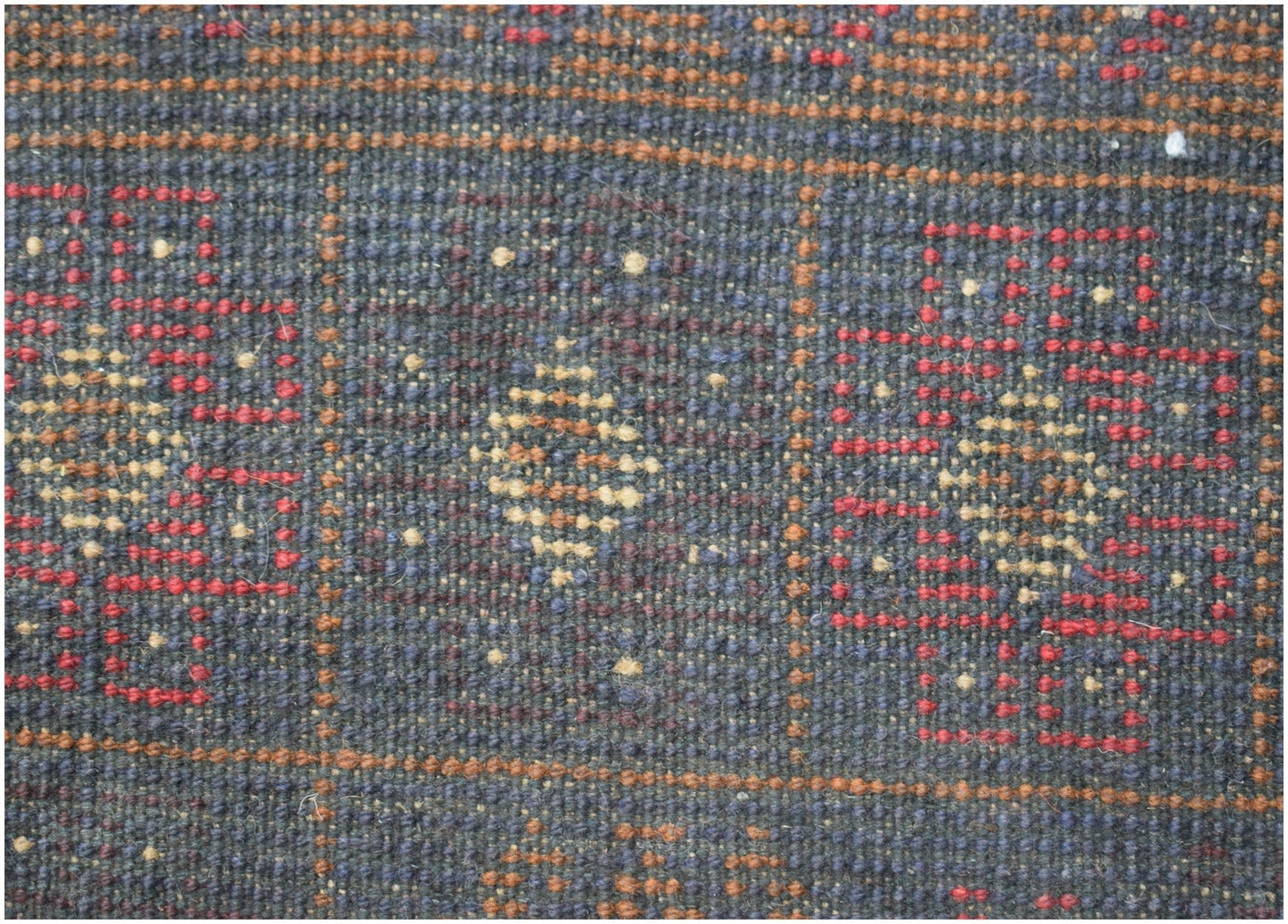 A handmade Afghan Baluch rug featuring a geometric pattern in dark red, blue, and ivory wool.