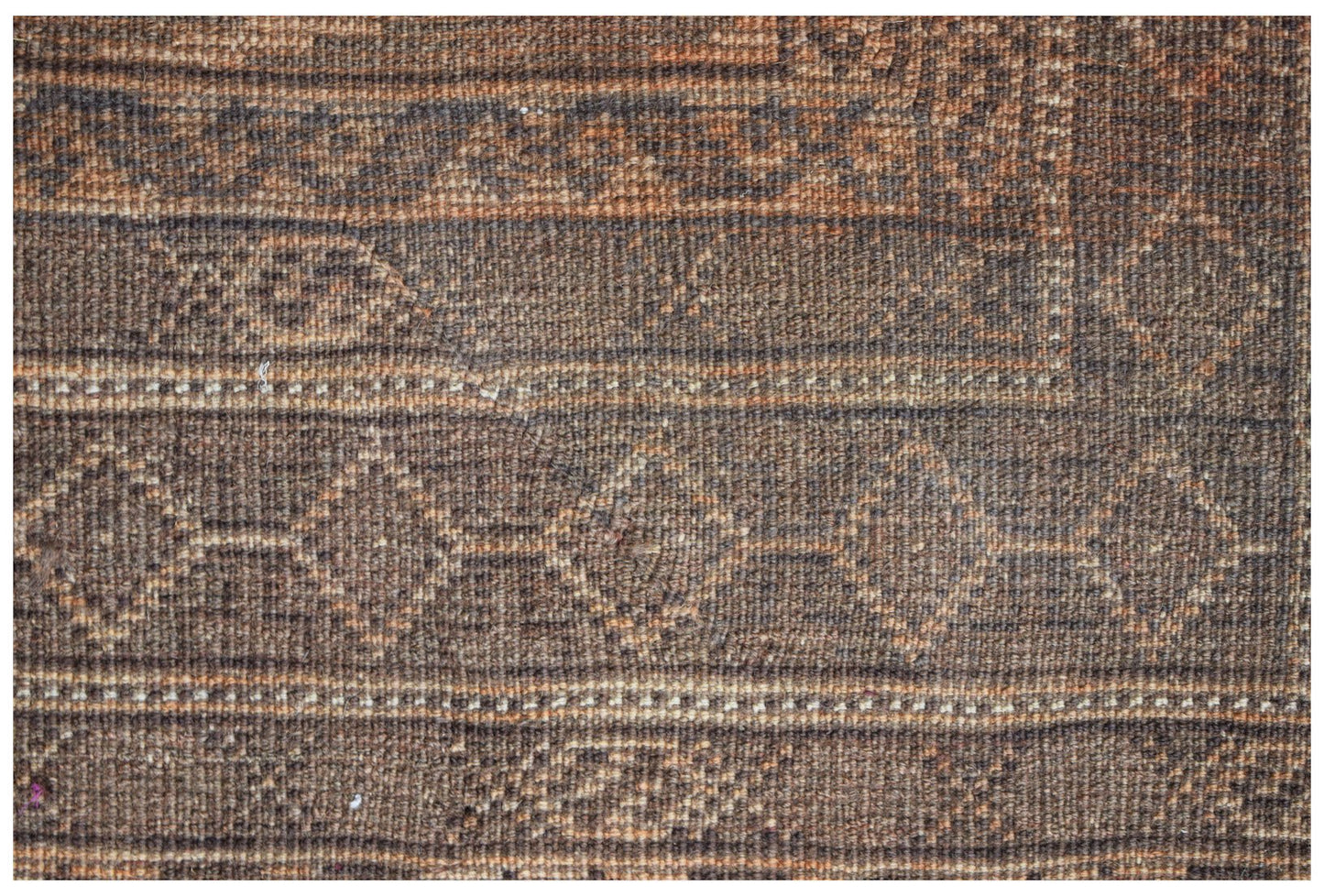 A handmade Afghan Baluch wool rug featuring a geometric diamond pattern in shades of brown.