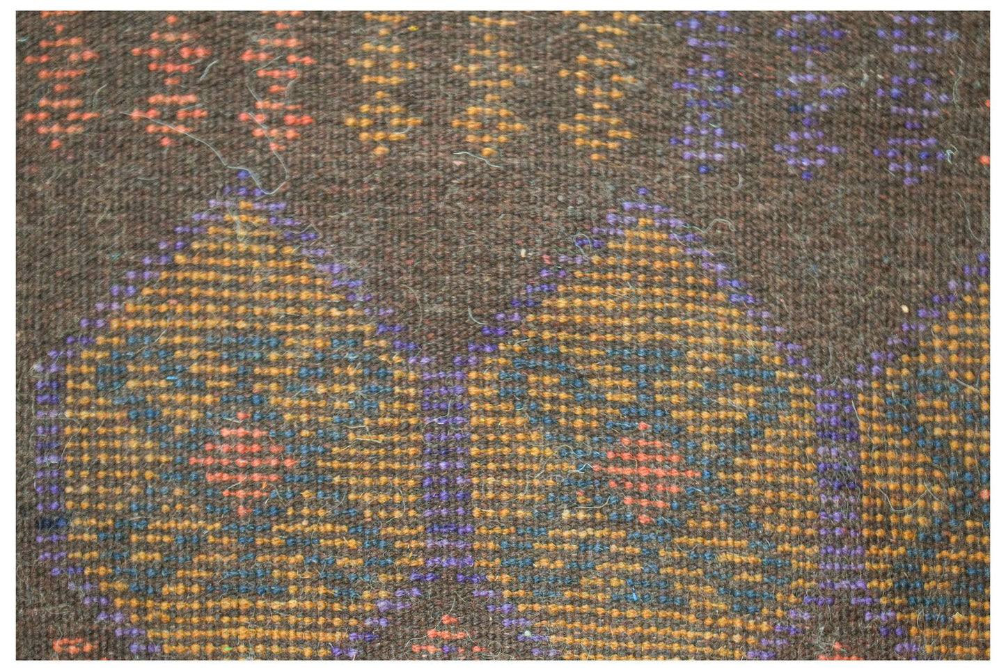 Handmade Afghan Pashm rug featuring a dark brown wool base with geometric patterns in blue and orange.