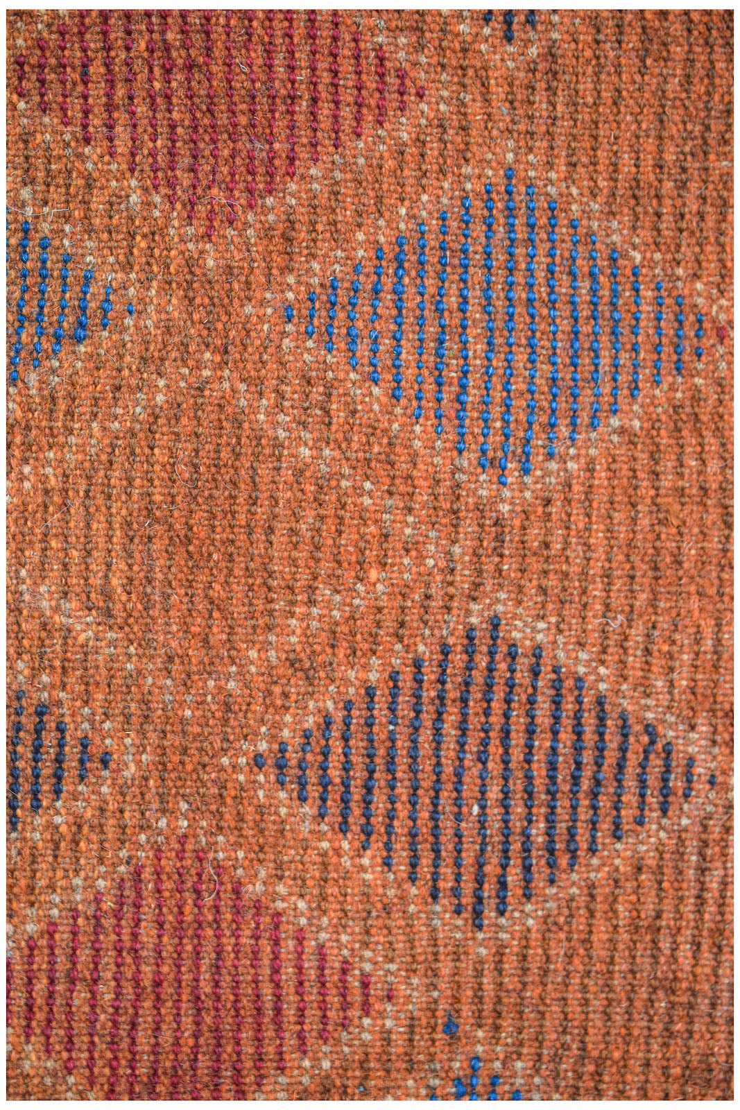 Afghan Pashm Rug with diamond pattern in blue and red on an orange background.