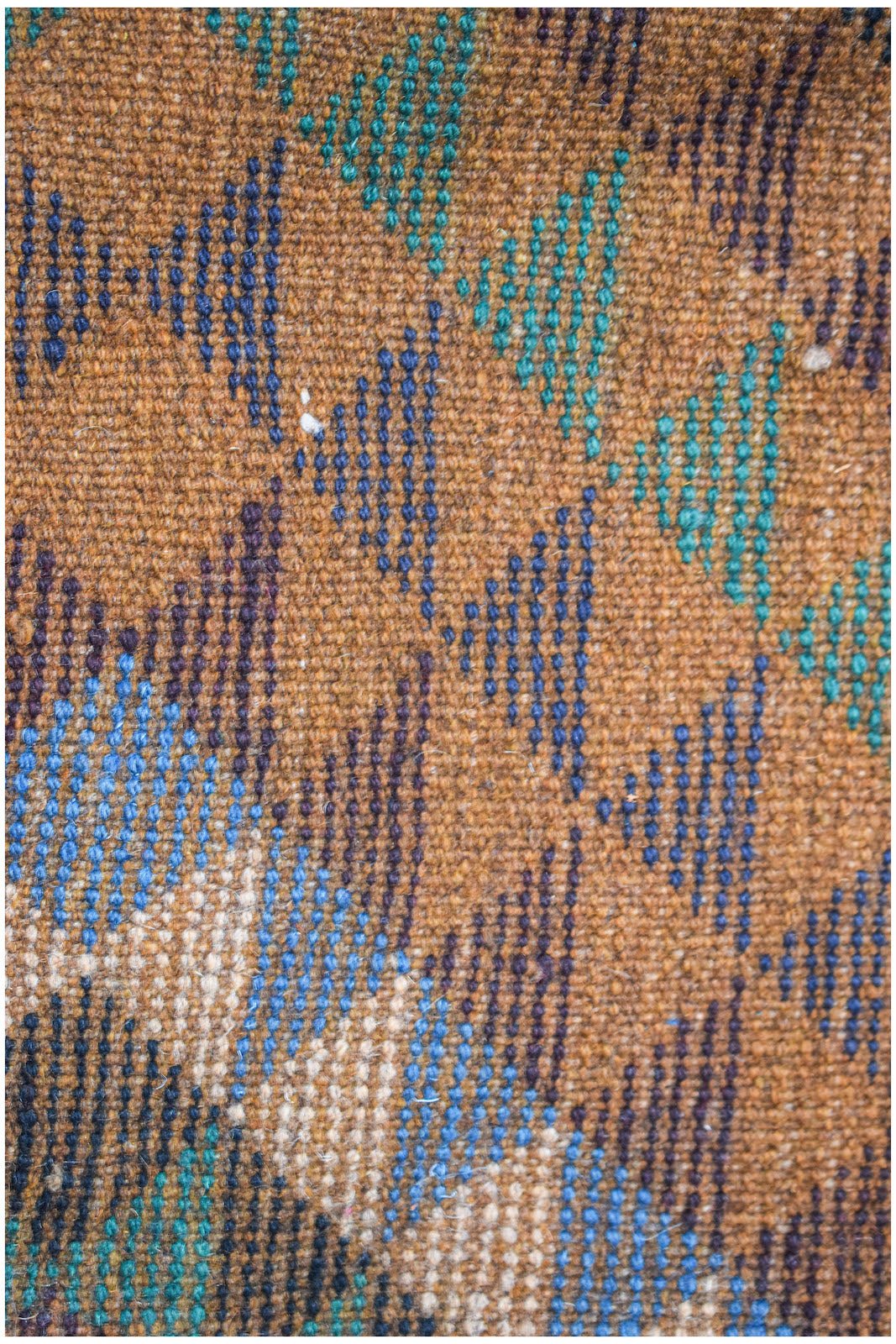 Handmade Afghan Pashm rug featuring traditional tribal patterns in deep red, brown, and blue tones.