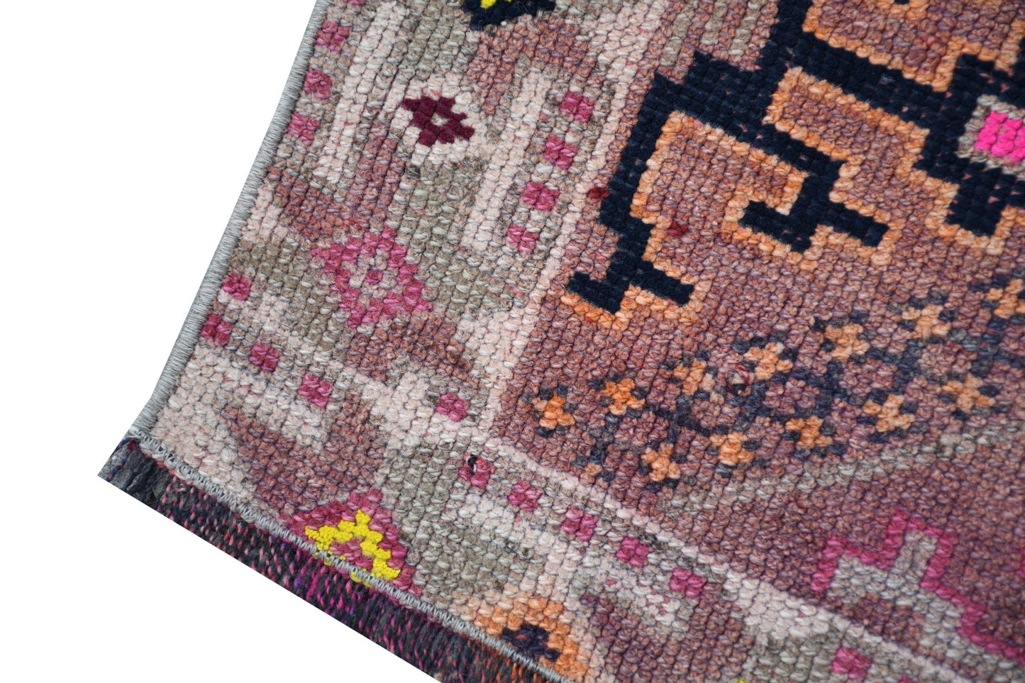 A vintage Kurdish Herki runner featuring tribal motifs in wool and neon nylon accents.