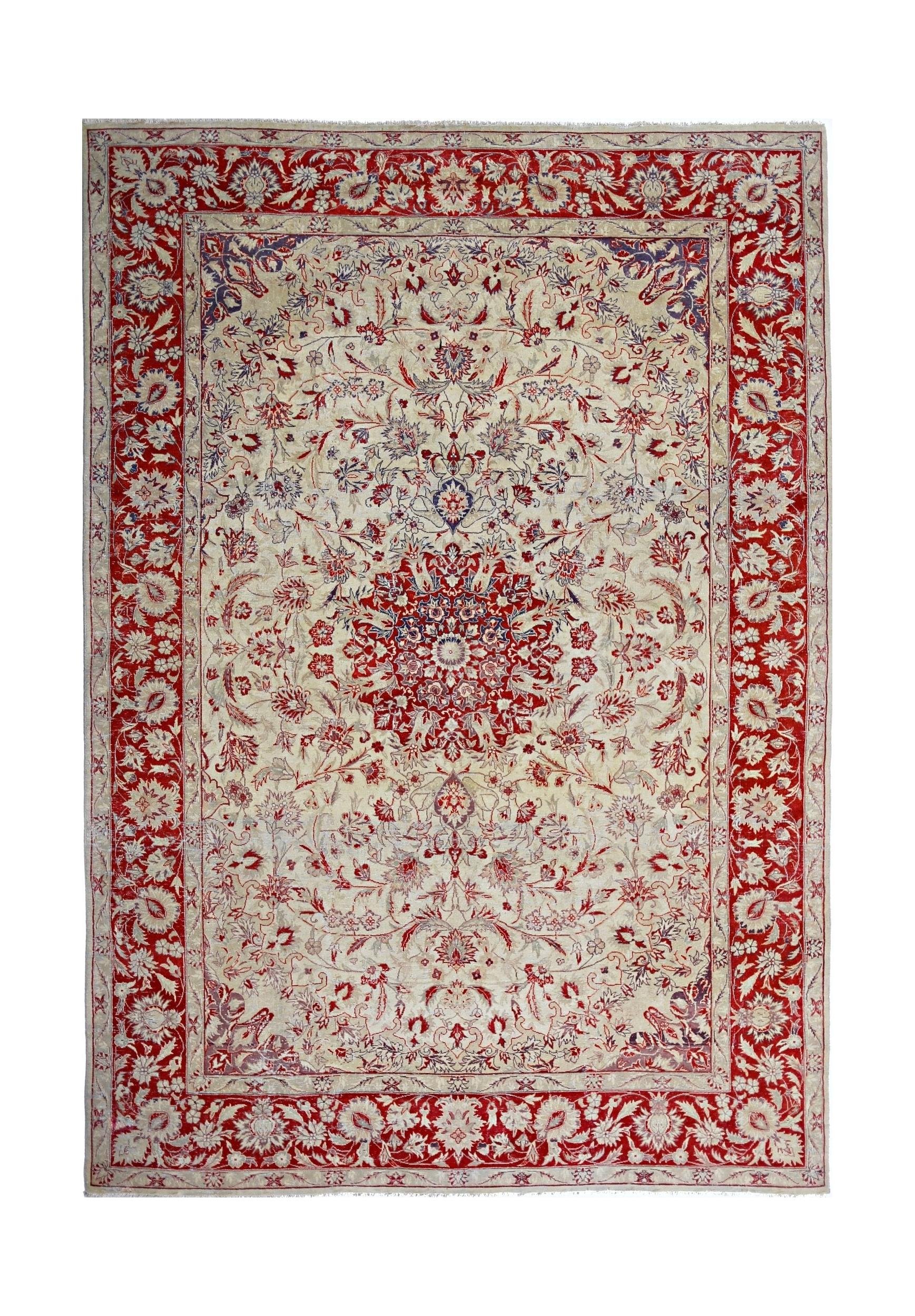 A vintage Pakistani rug featuring a central floral medallion on a cream field with a red border.