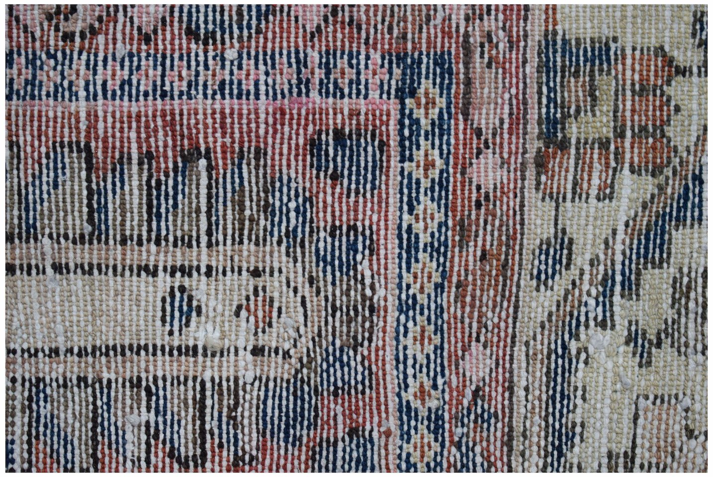 A close-up view of a vintage Persian Bakhtiari rug featuring intricate geometric patterns in wool.