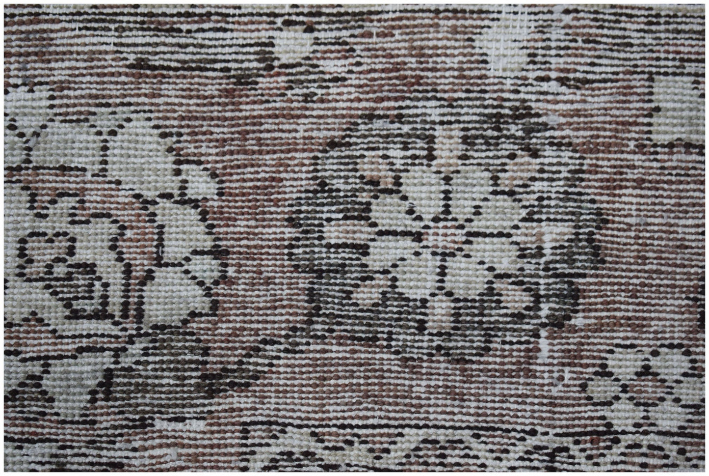 A vintage Persian Bakhtiari rug featuring intricate floral patterns in muted earth tones.
