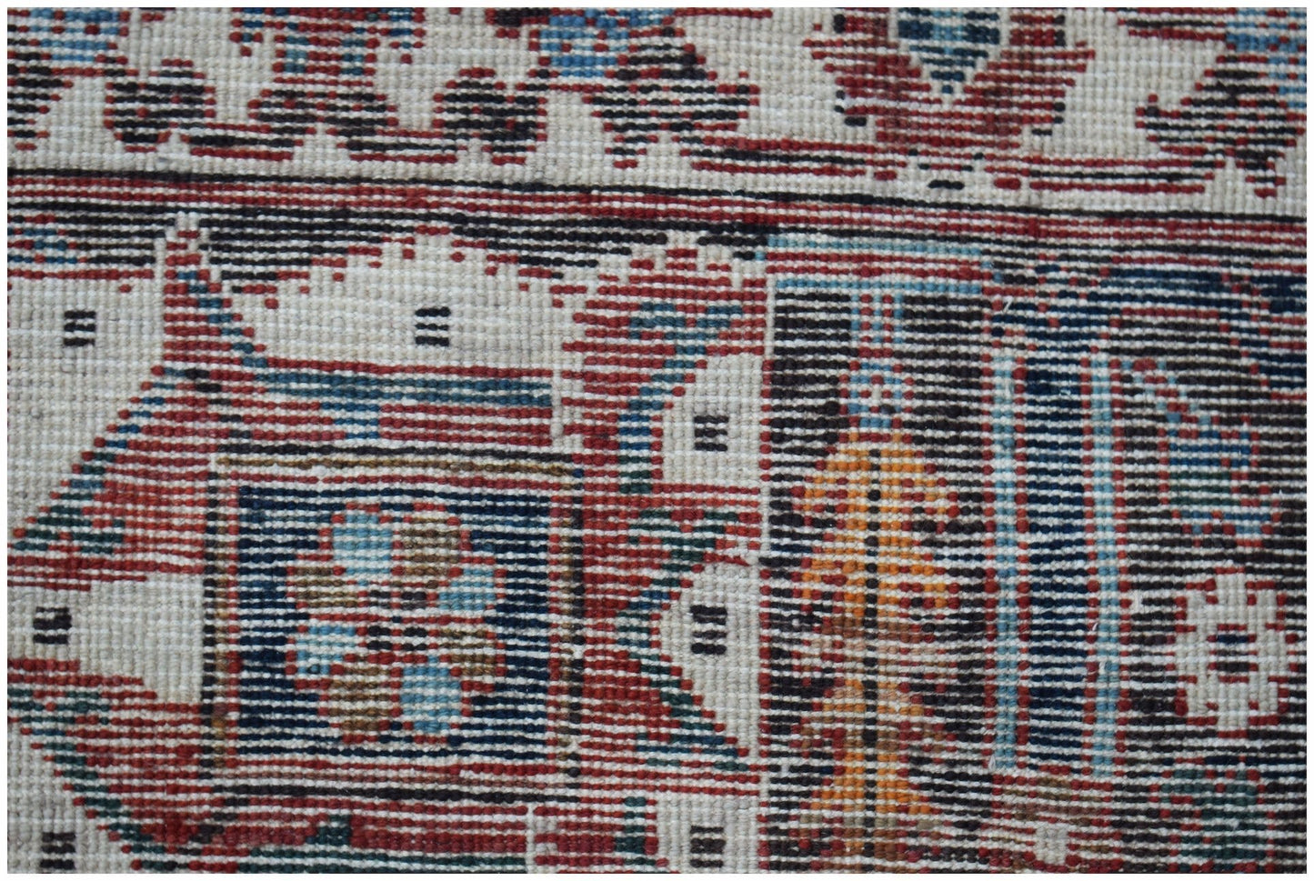 A close-up of a vintage Persian Ghashghai rug featuring intricate geometric and floral patterns.