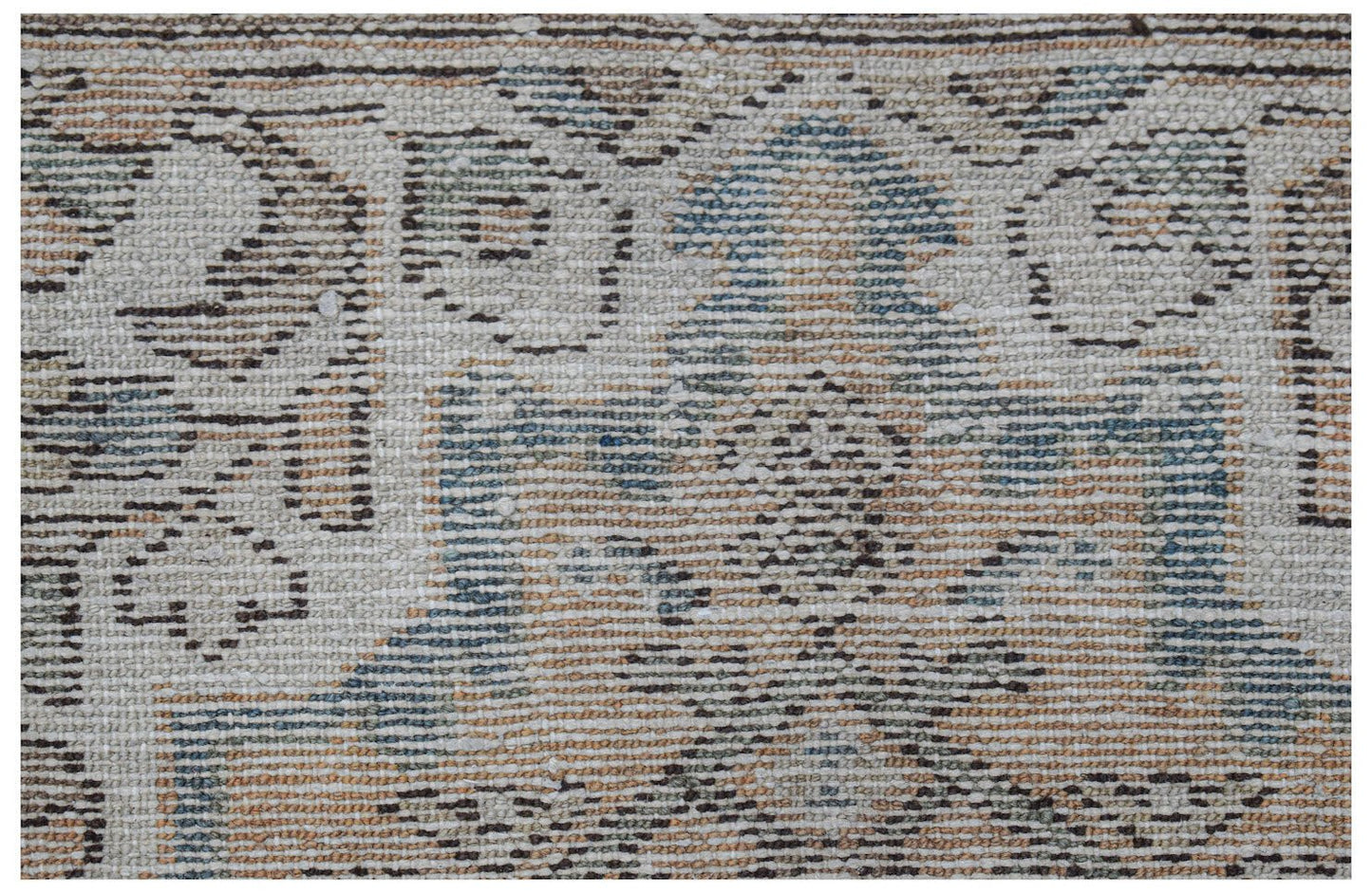 A handwoven vintage Persian runner featuring a faded geometric pattern in blue and tan tones.