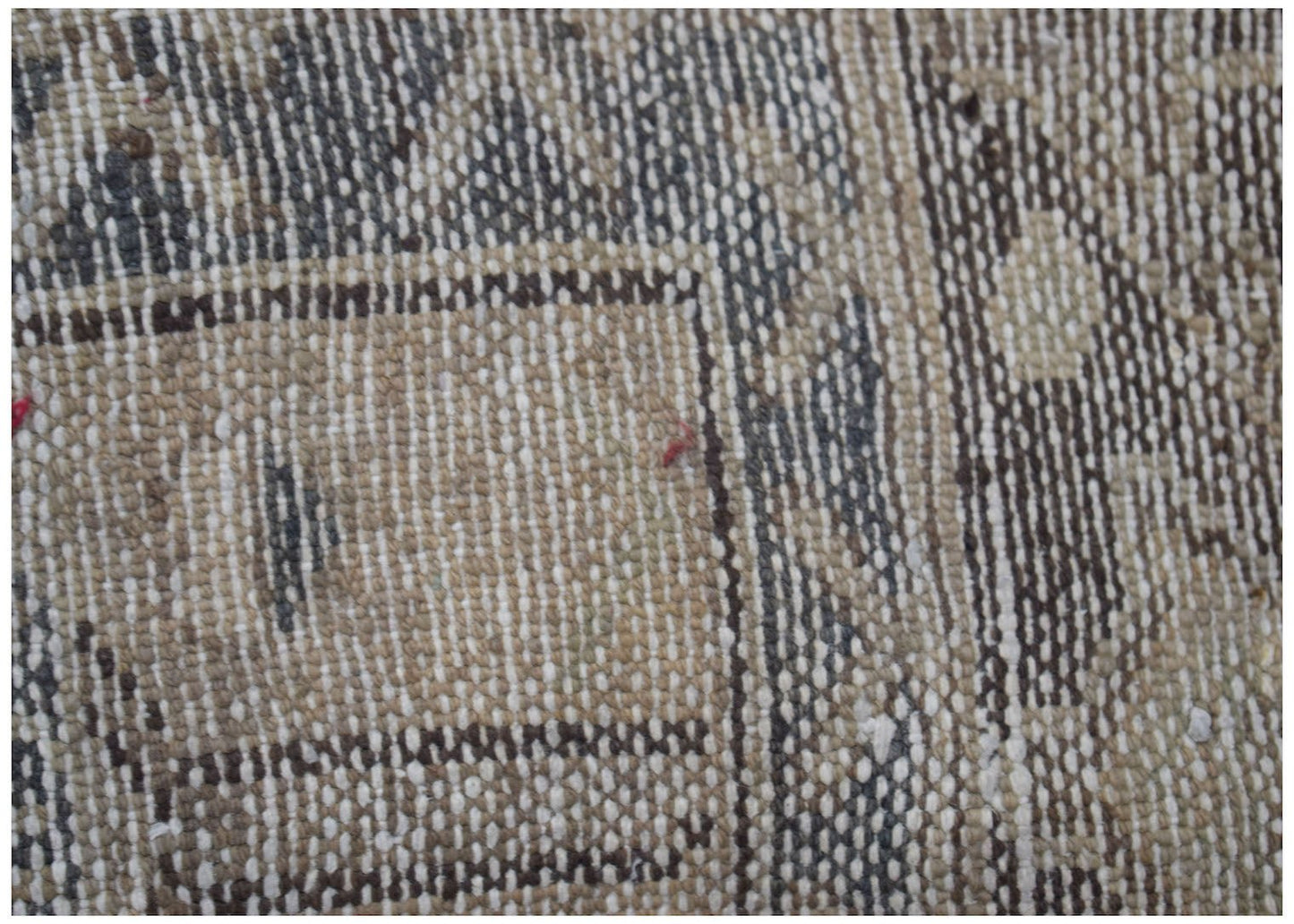 A close-up view of a vintage Persian Hamadan runner featuring intricate woven wool patterns.