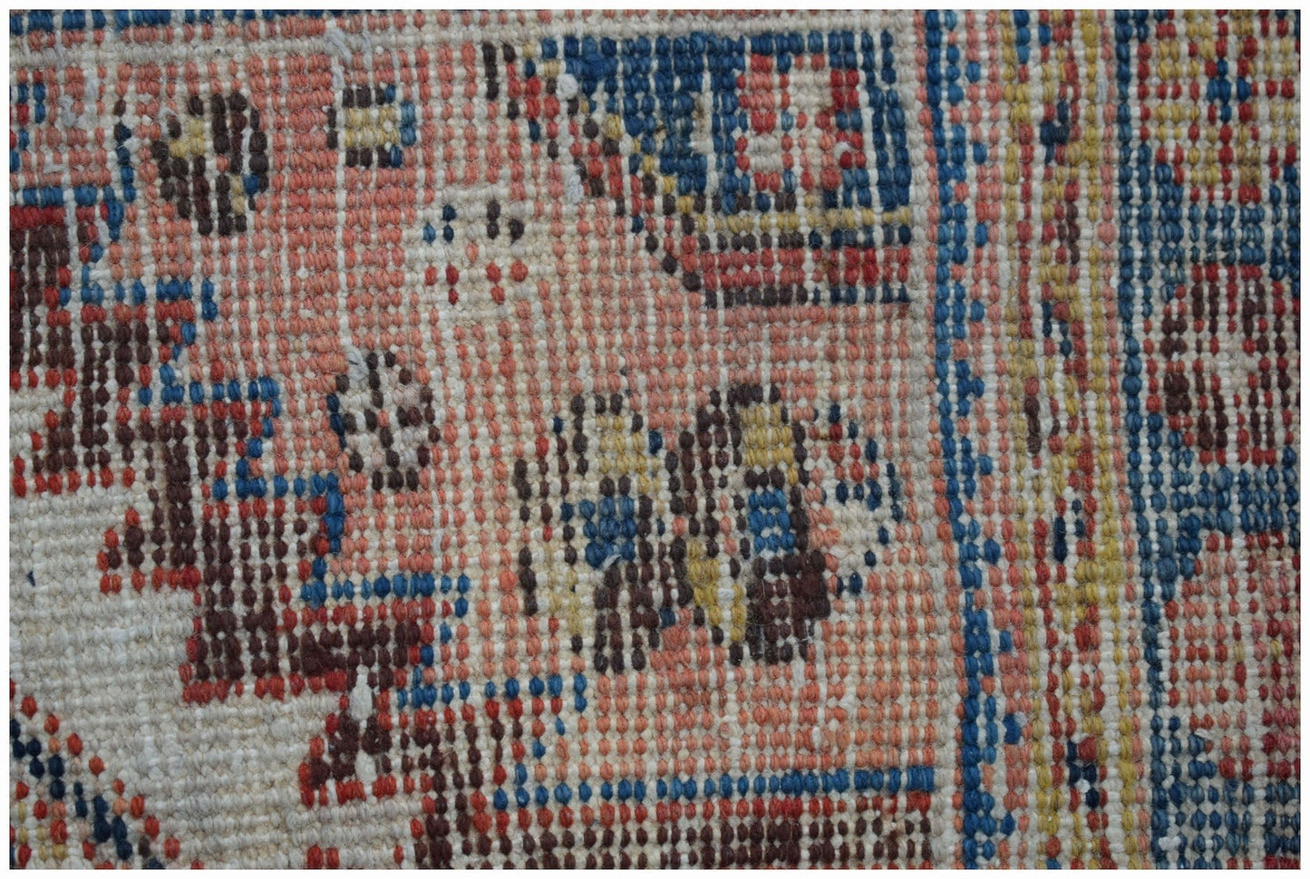 A close-up view of a vintage Persian Hamadan rug featuring intricate geometric patterns in wool.