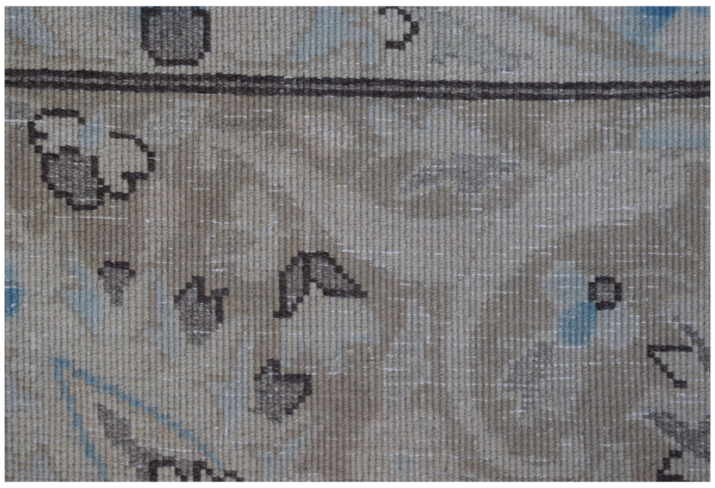 Close-up of a vintage Persian Kerman rug featuring intricate floral motifs in soft neutral tones.