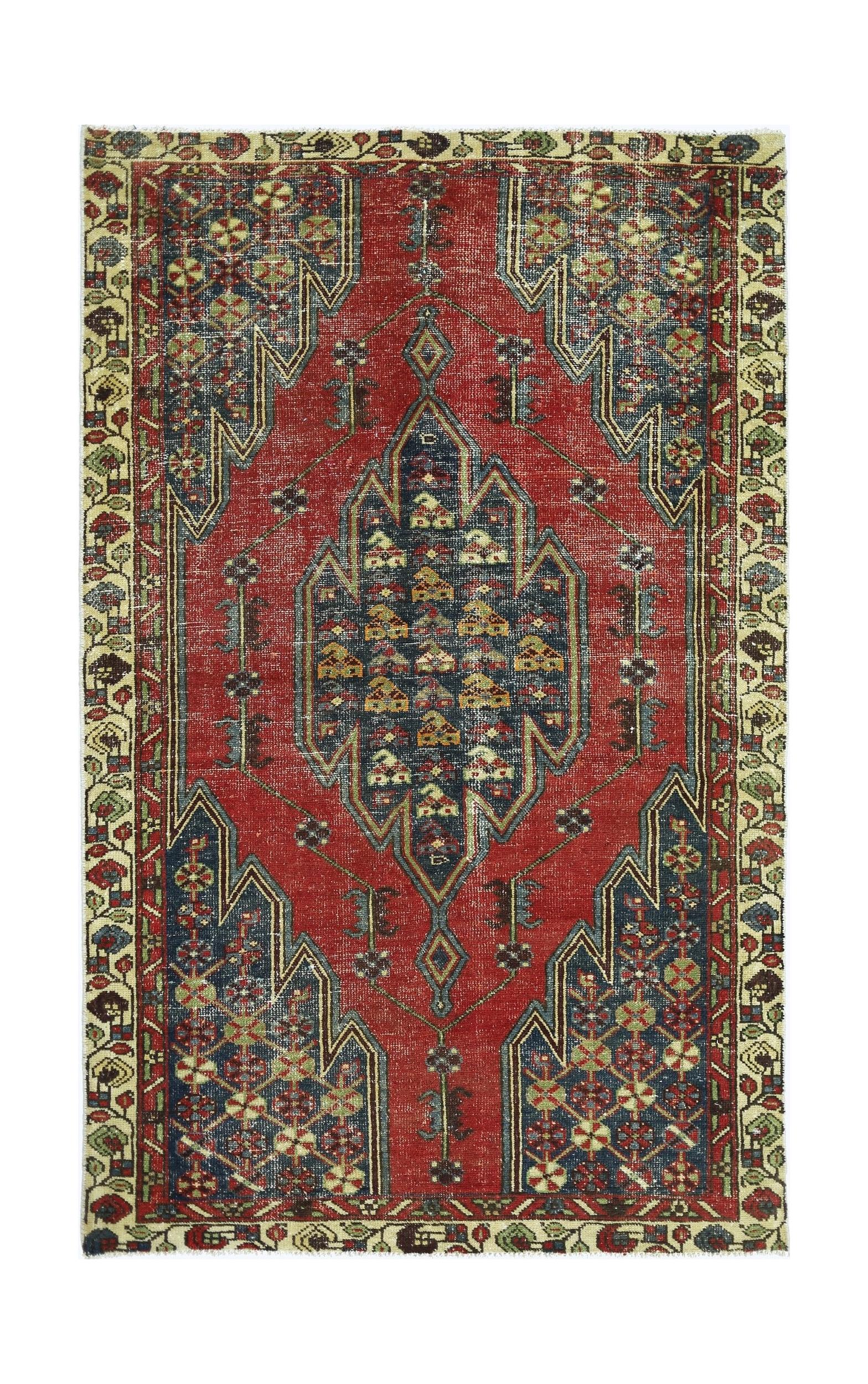 A vintage Persian Mazlaghan rug featuring a central geometric medallion on a red field.