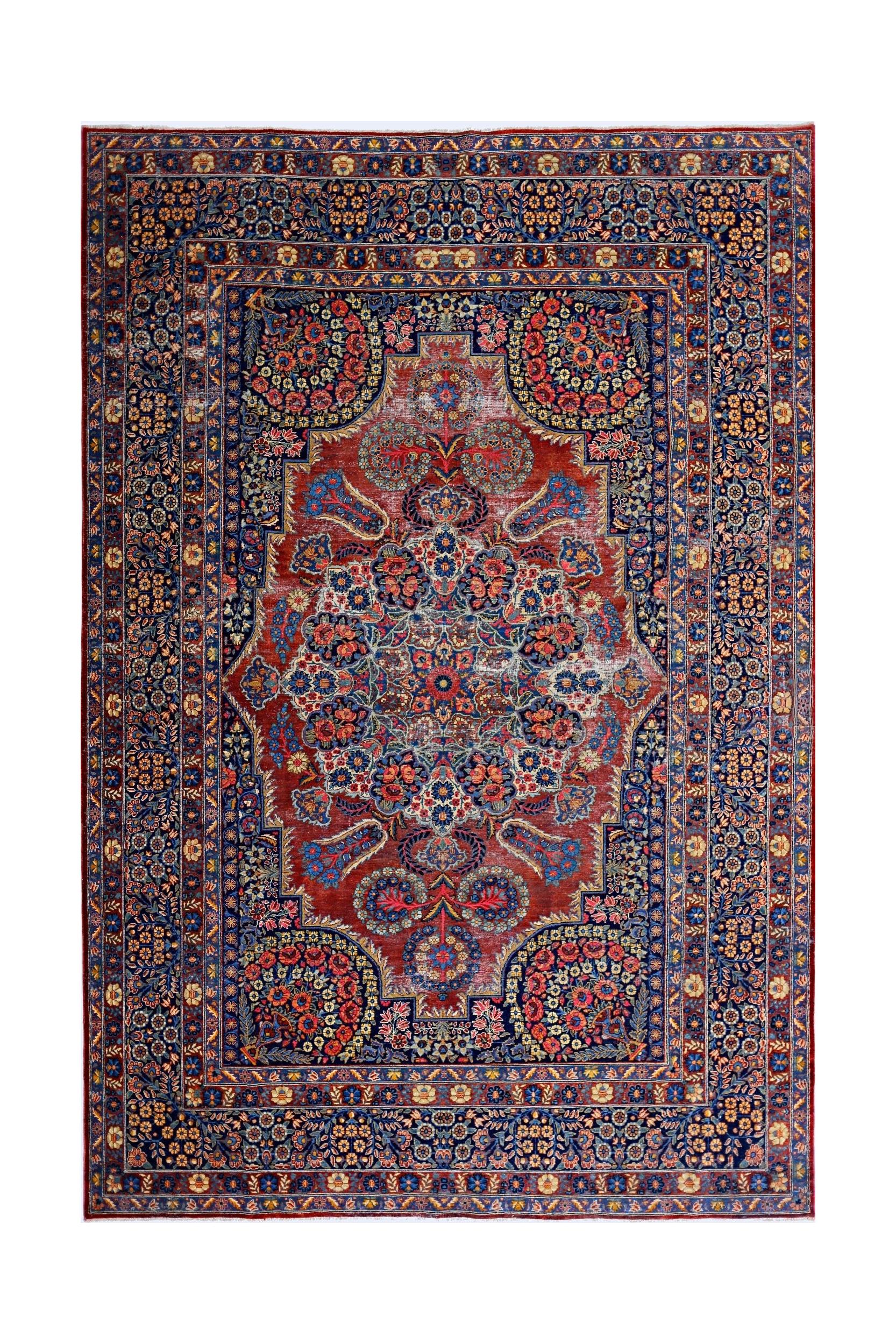 A vintage Persian Moud rug featuring a central floral medallion on a red field with blue borders.