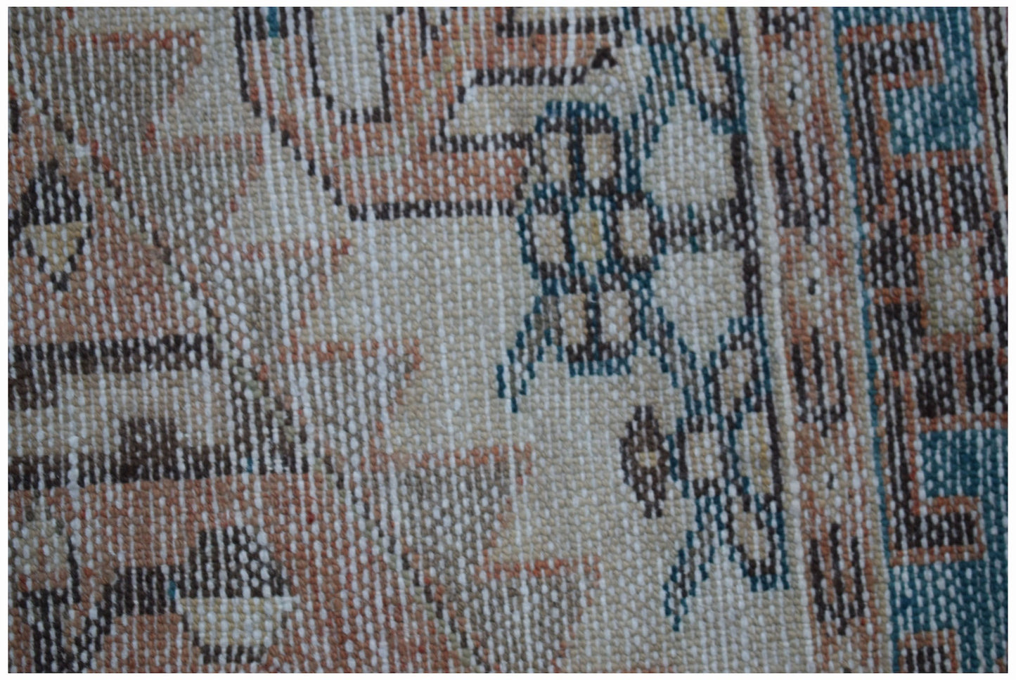 A close-up of a vintage Persian Hamadan rug featuring intricate geometric patterns in wool.
