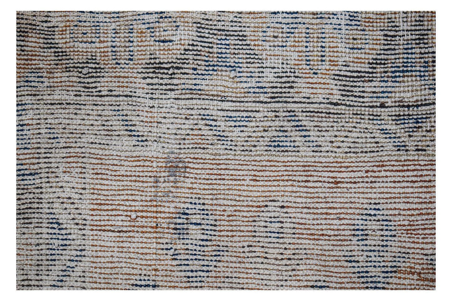 A handwoven vintage Persian rug featuring a distressed pattern in blue, brown, and cream tones.