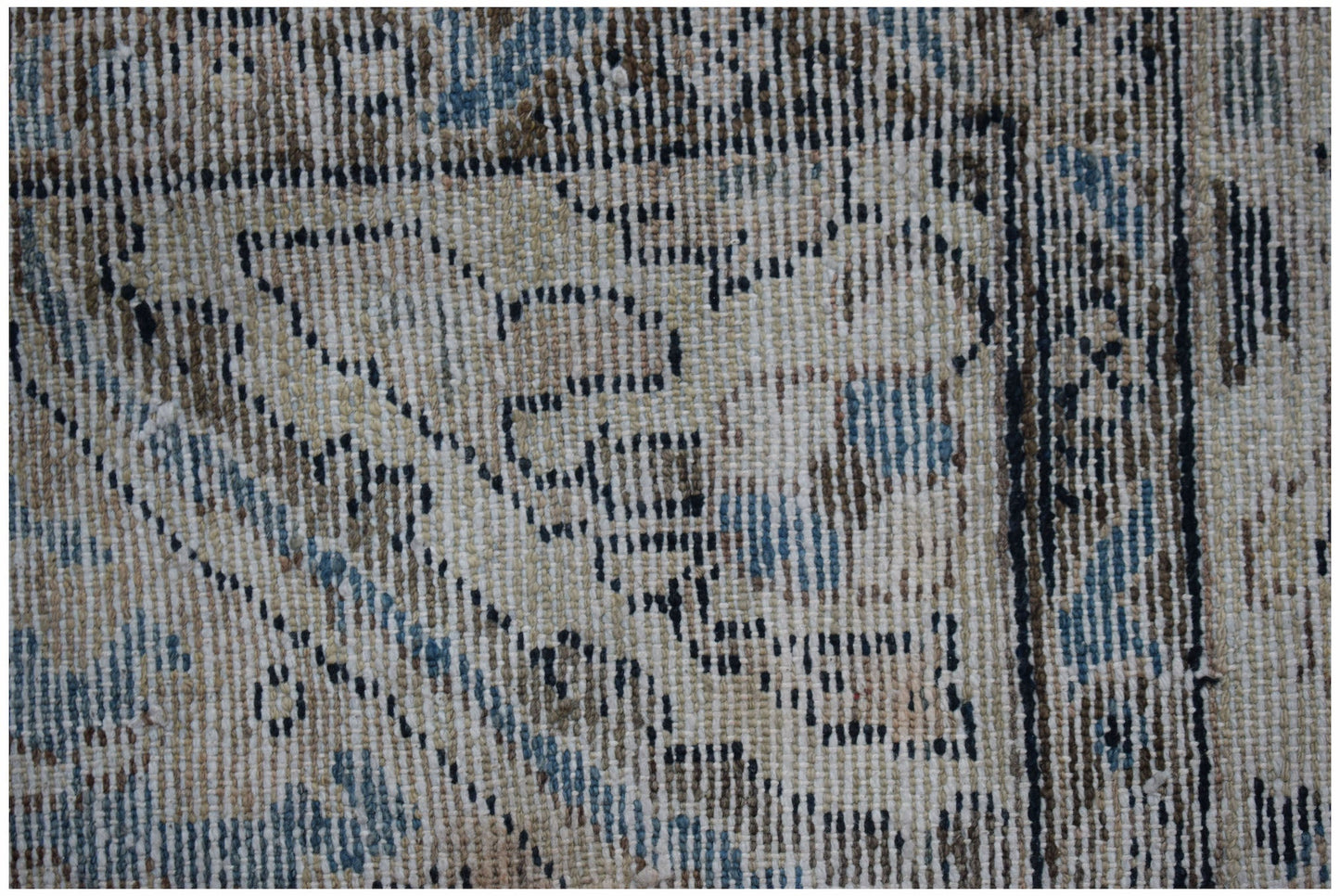 Close-up of a vintage Persian Sarouk rug featuring intricate floral patterns in blue and beige.