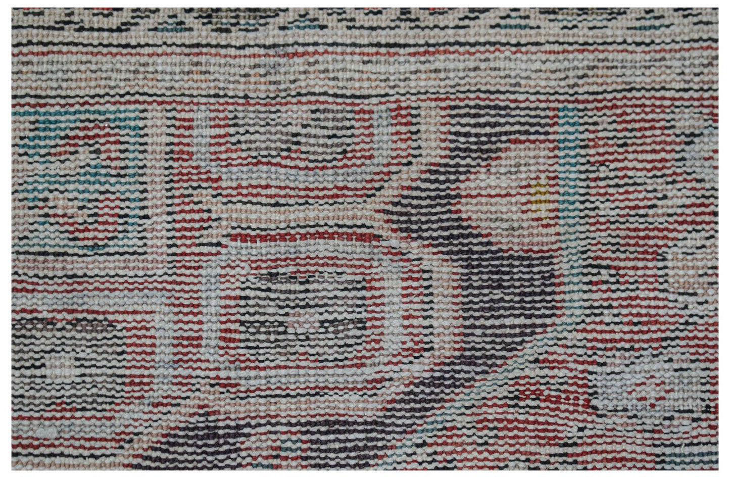 Vintage Persian rug with a distressed pattern in red, blue, and black.