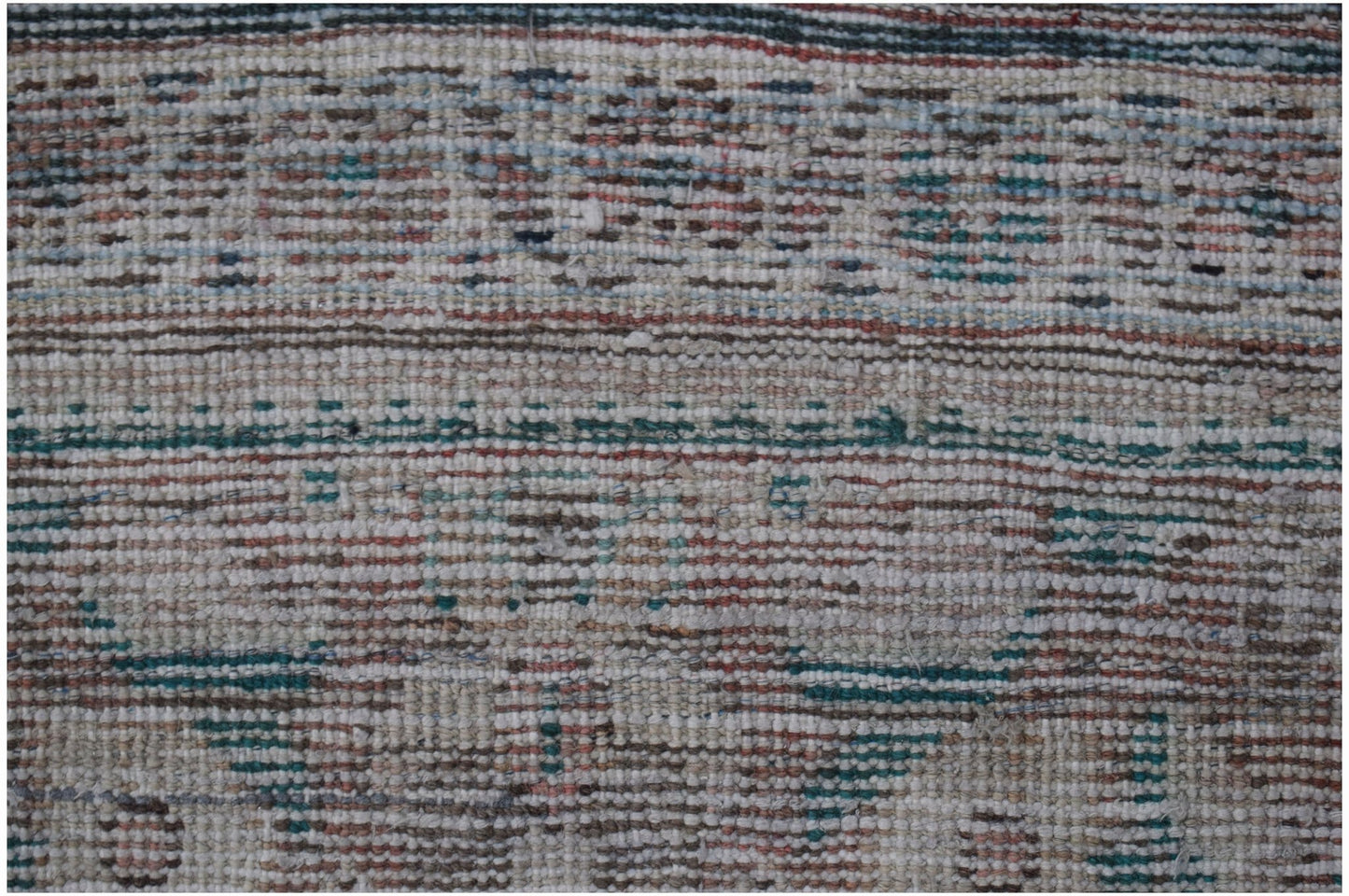 A handwoven vintage Persian Mahal rug featuring a faded geometric pattern in muted earth tones.