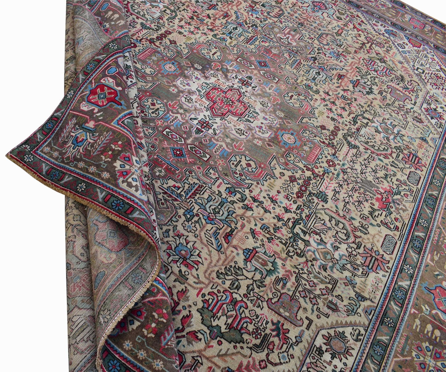 A vintage handwoven Persian Tabriz rug featuring intricate floral patterns in a muted color palette.