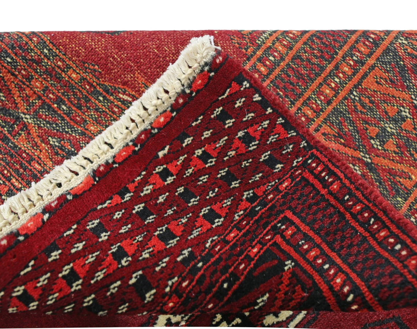 A vintage Pakistani Princess Bokhara rug featuring a rich red geometric pattern and wool pile.