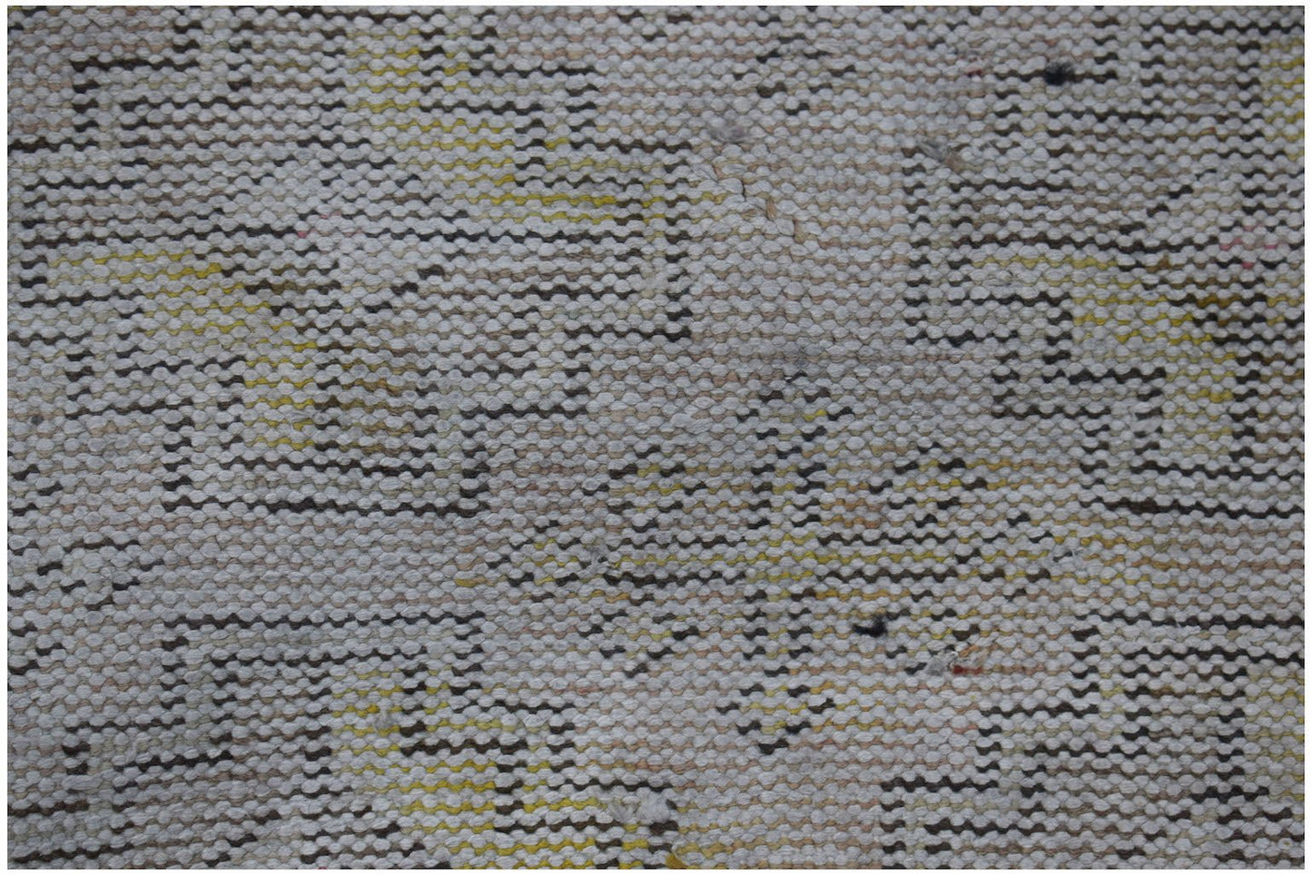 A close-up of a vintage Turkish Isparta runner featuring a faded geometric pattern in wool.