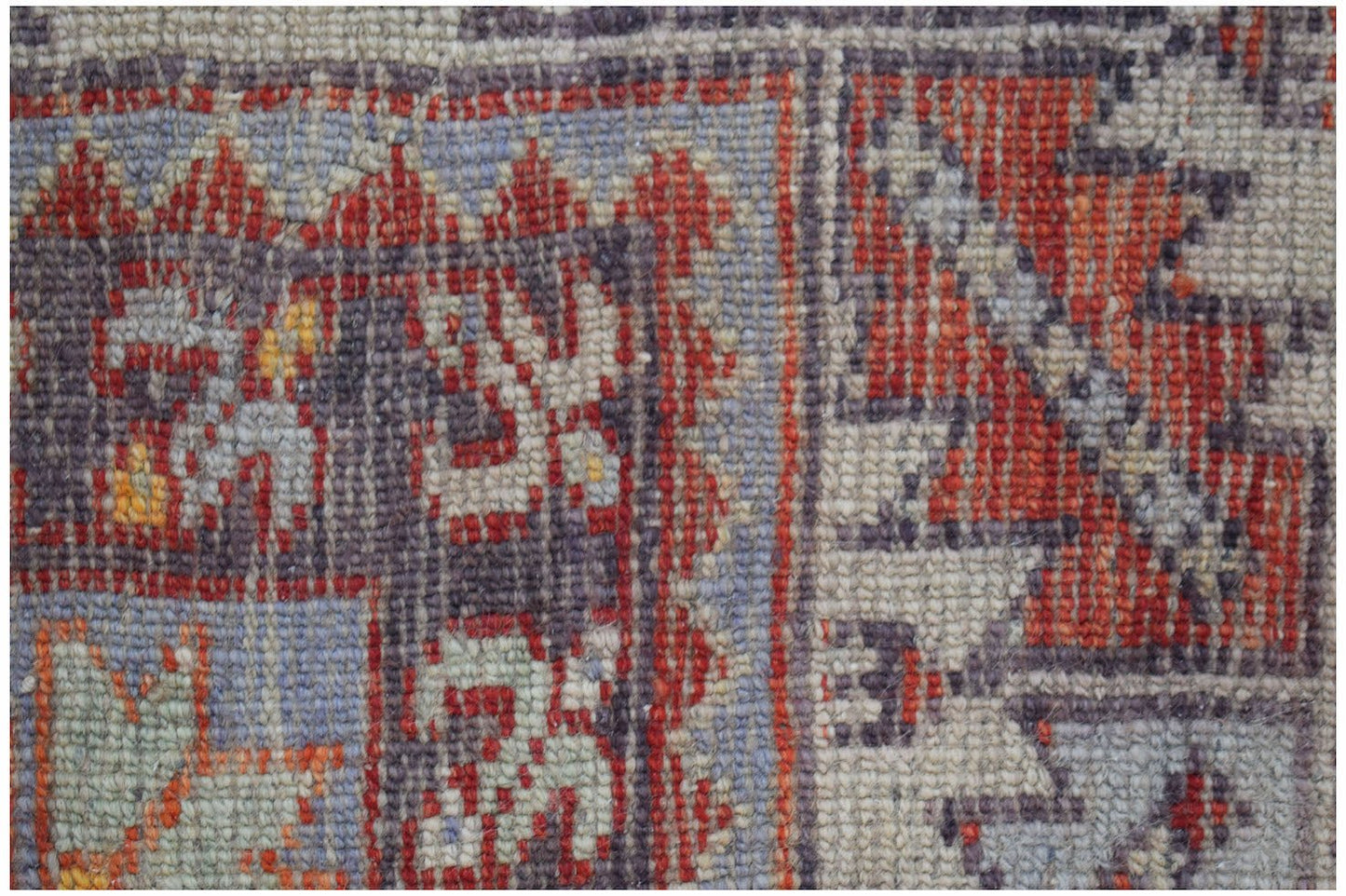 A close-up view of a vintage Turkish Kula rug featuring intricate geometric patterns in wool.