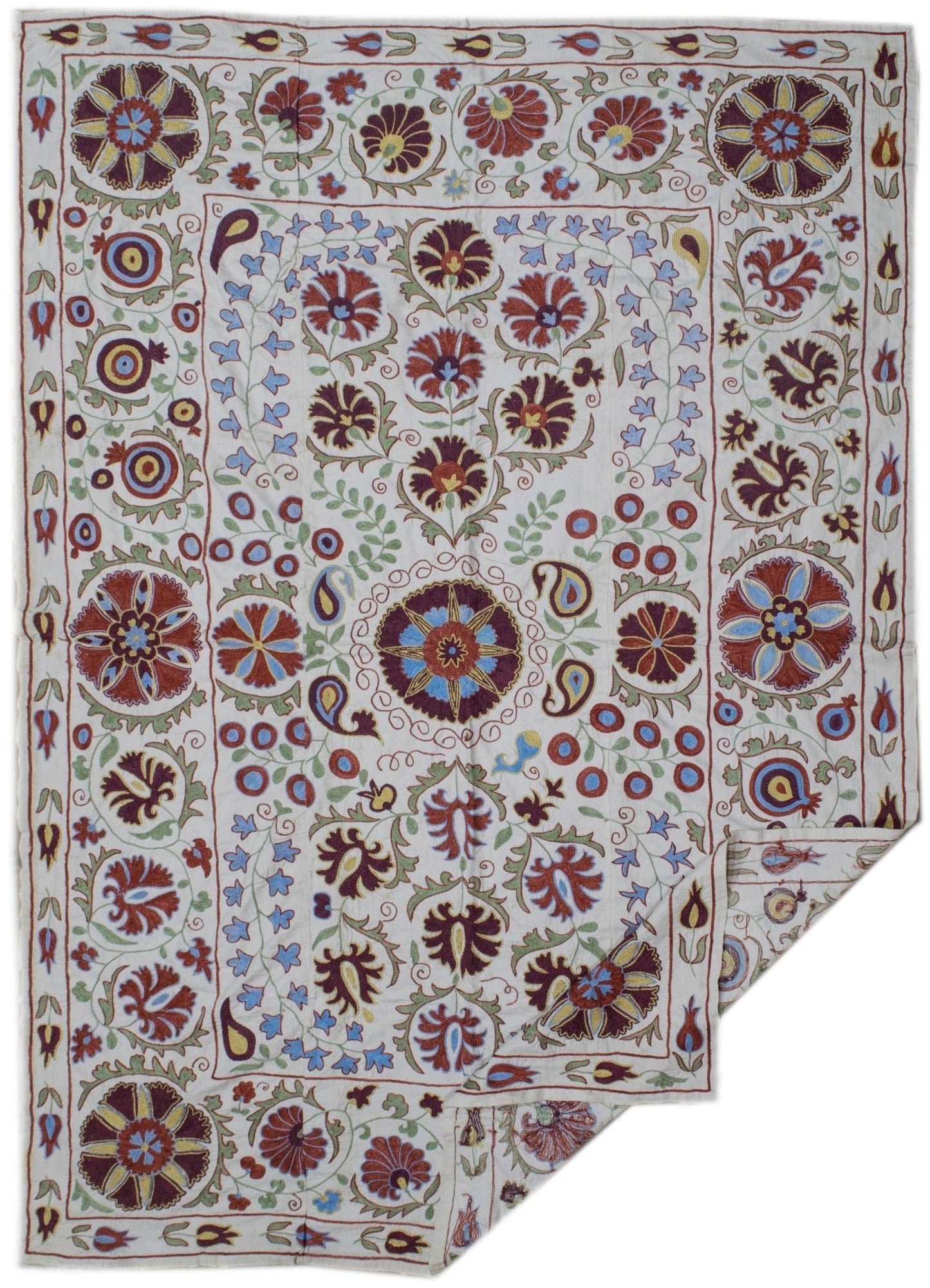 Handmade Uzbek suzani featuring intricate floral and botanical embroidery on a cotton base.