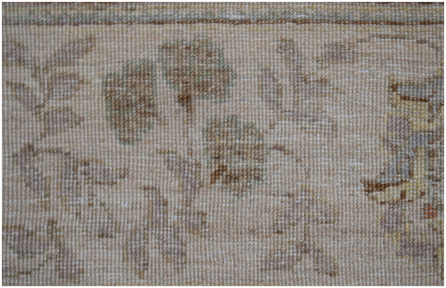 A close-up of an Afghan Chobi rug featuring a traditional floral pattern in soft, earthy tones.