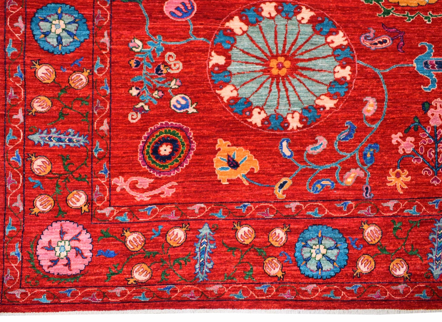 A handmade Afghan Chobi rug featuring intricate floral and geometric patterns in vibrant red.