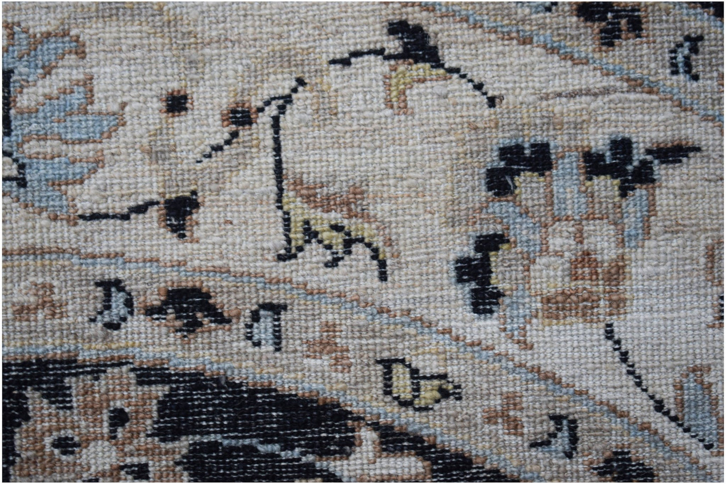 A close-up of a handwoven Afghan Chobi rug featuring intricate floral patterns in earthy tones.
