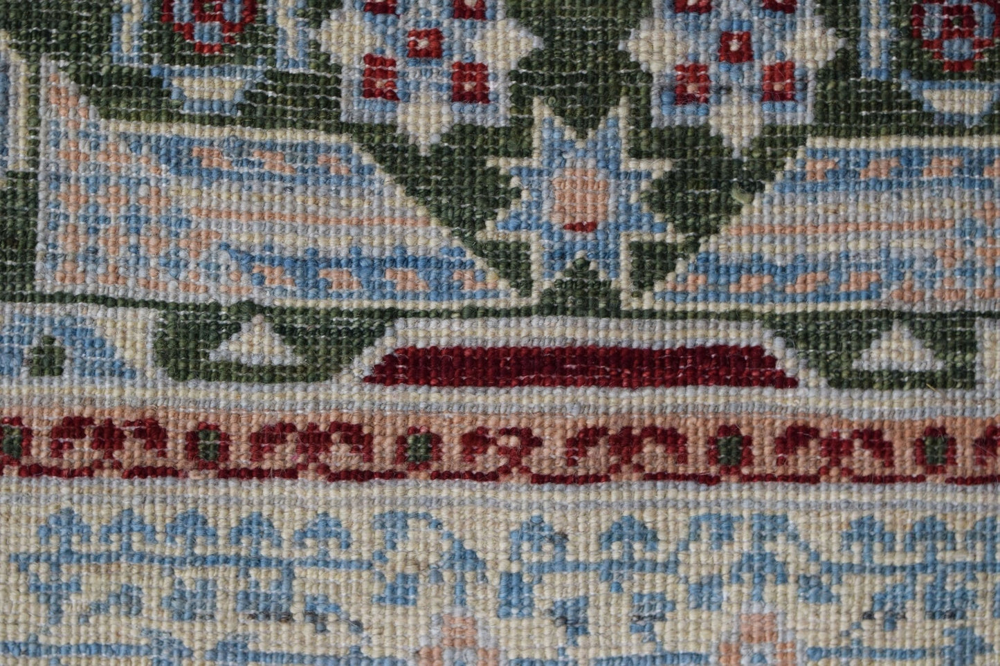 A close-up of a handwoven Afghan Chobi runner featuring a detailed Mamluk geometric pattern.