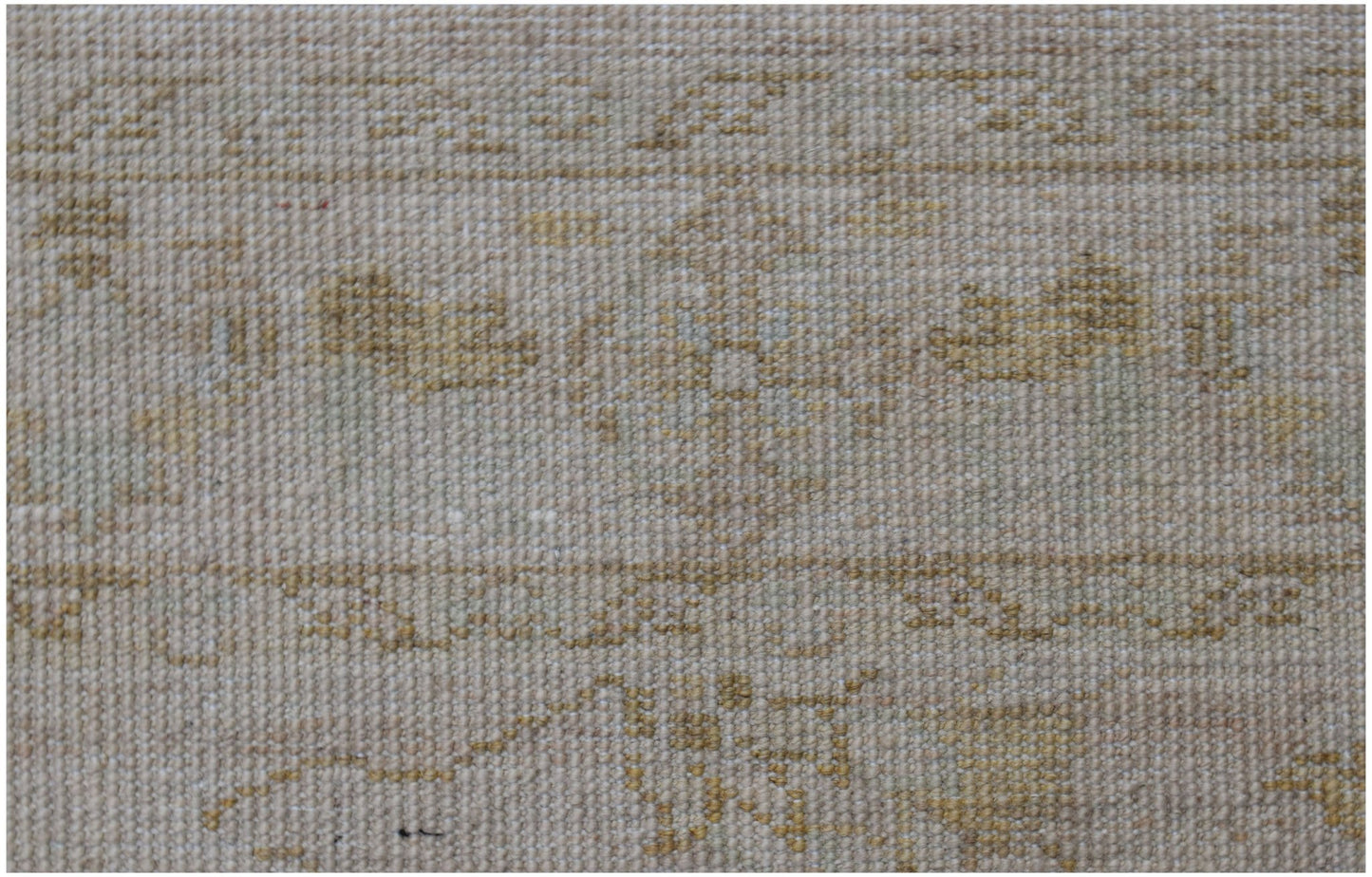 A close-up of a handwoven Afghan Chobi rug featuring a neutral palette with subtle wood-toned motifs.