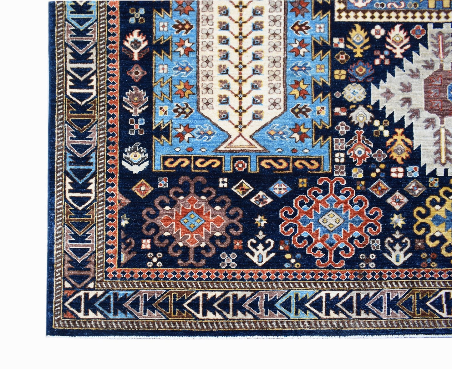 A handmade Afghan Chobi rug featuring a deep blue field with intricate geometric and floral motifs.