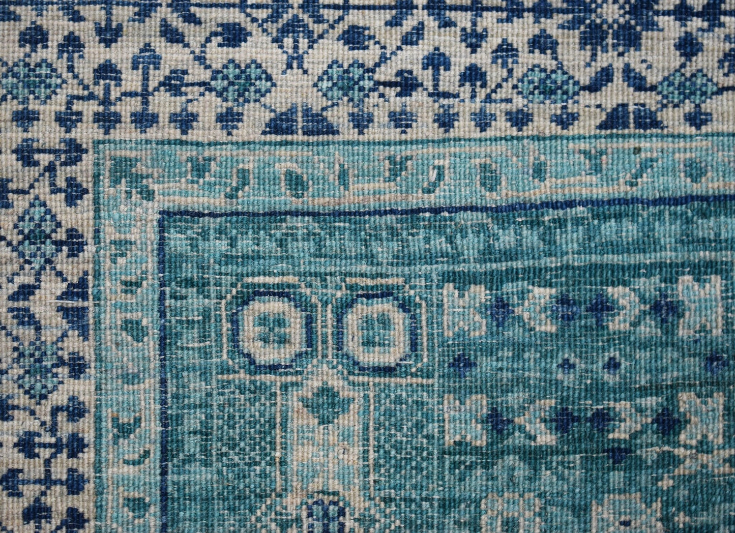 A handwoven Afghan Balkh rug featuring a detailed blue and cream Mamluk geometric pattern.