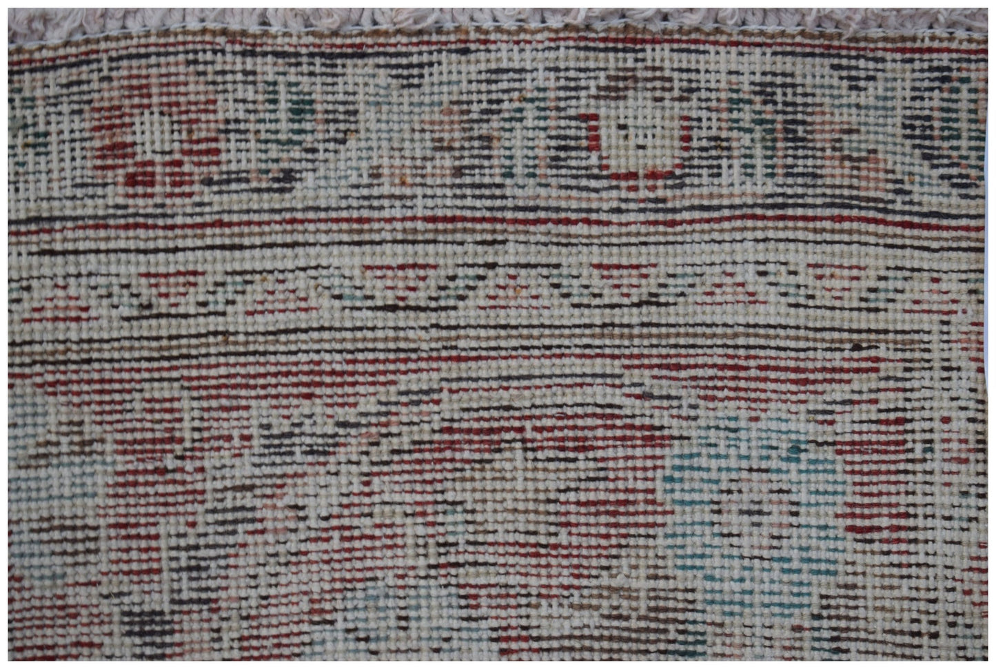 A close-up view of a vintage handwoven Persian Tabriz rug featuring intricate floral patterns.